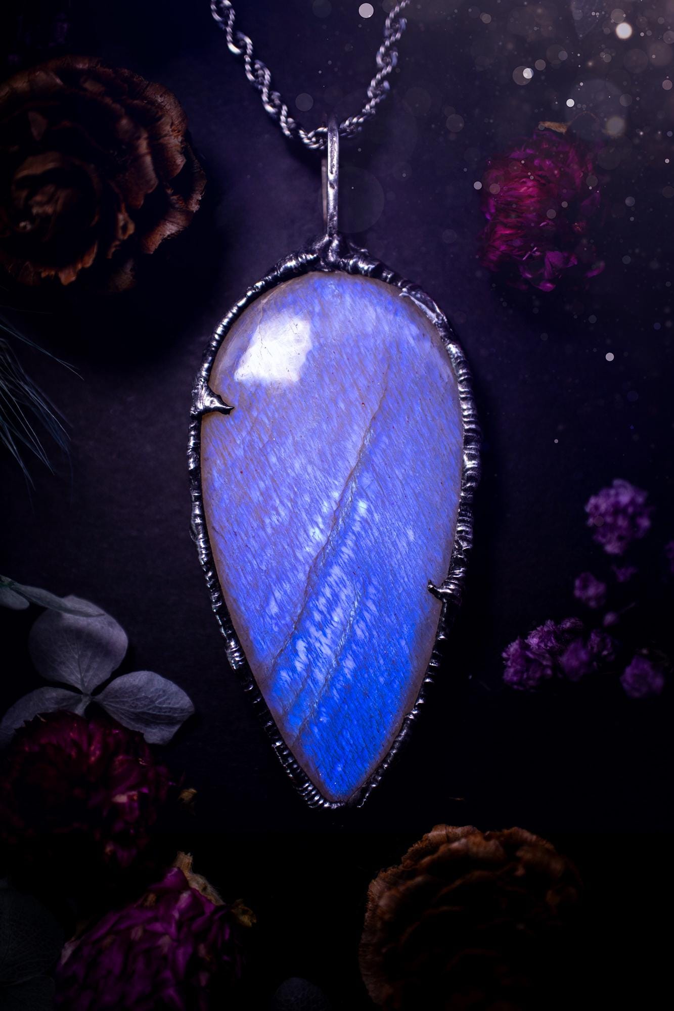 Handmade and beautiful, flashy belomorite, soft soldered pendant necklace. This pendant necklace features the most gorgeous and flashy belomorite moonstone crystal, full of glittery shimmer and a deep lovely blue hue. Handcrafted using the soft solder method, also known as the tiffany technique, an ancient technique used to created stained glass windows. The solder used is lead free and totally safe to wear, it contains elements of silver and polishes up to a high lustre. Gothic witchy jewellery