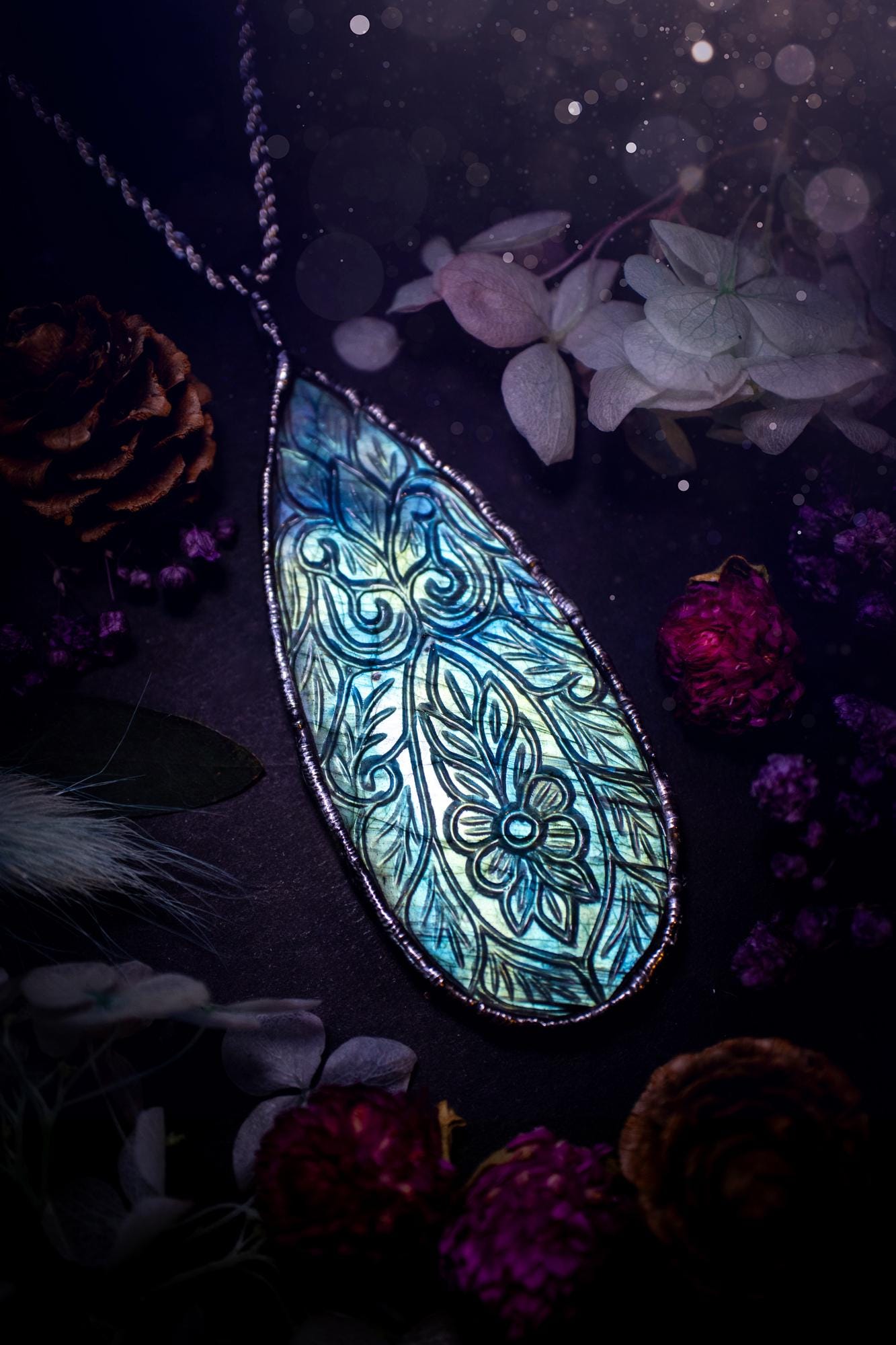 Beautifully handmade and bespoke, carved labradorite, soft soldered pendant necklace. This large labradorite pendant has been crafted using the soft solder method, also known as the tiffany technique. The crystal has a bezel of lead free soft solder which contains small parts of silver that allows for oxidisation and a high lustre polish. This labradorite is full of beautiful blues and greens and has been hand carved with a beautiful floral and leaf pattern. One off, gothic and witchy jewellery