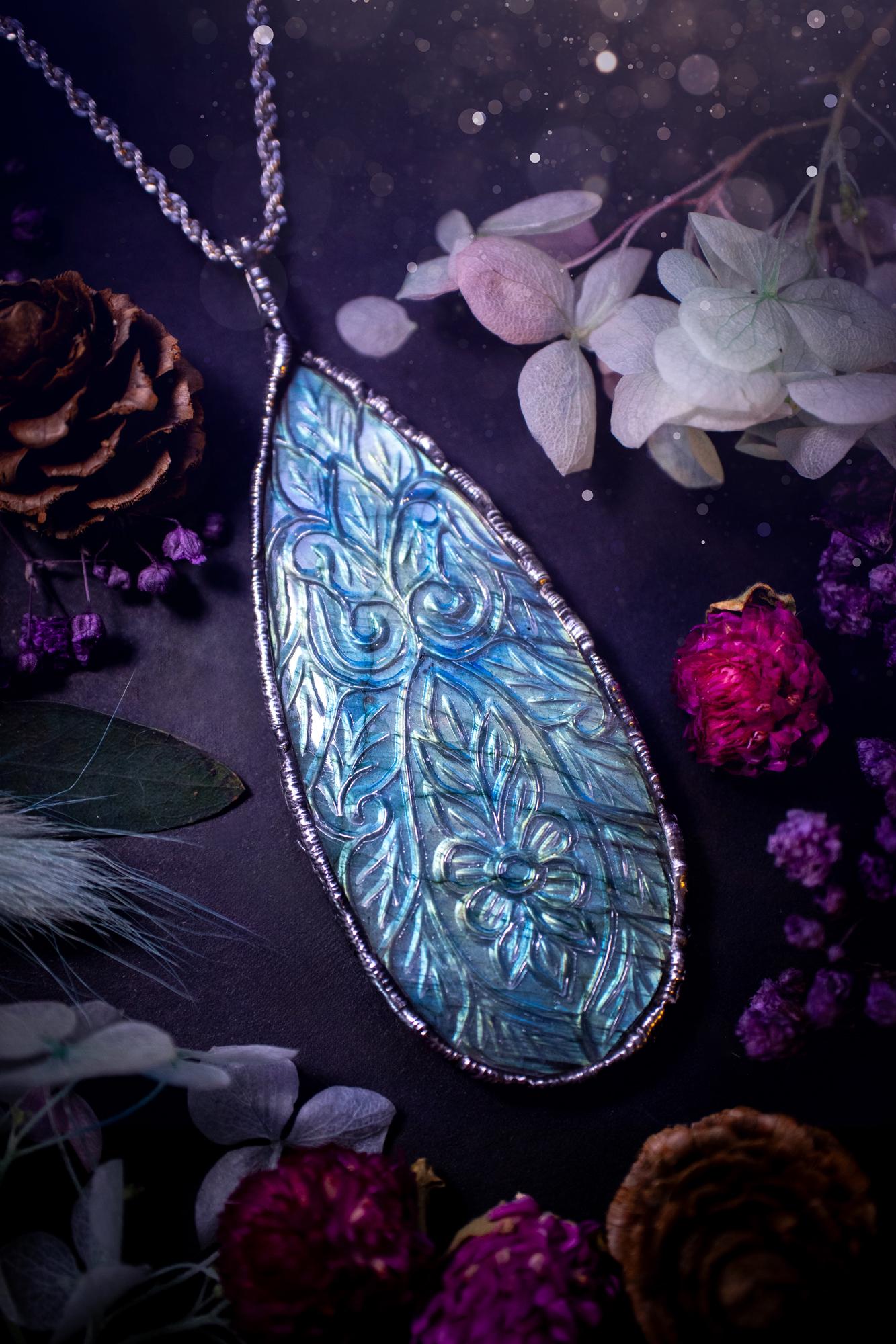 Beautifully handmade and bespoke, carved labradorite, soft soldered pendant necklace. This large labradorite pendant has been crafted using the soft solder method, also known as the tiffany technique. The crystal has a bezel of lead free soft solder which contains small parts of silver that allows for oxidisation and a high lustre polish. This labradorite is full of beautiful blues and greens and has been hand carved with a beautiful floral and leaf pattern. One off, gothic and witchy jewellery
