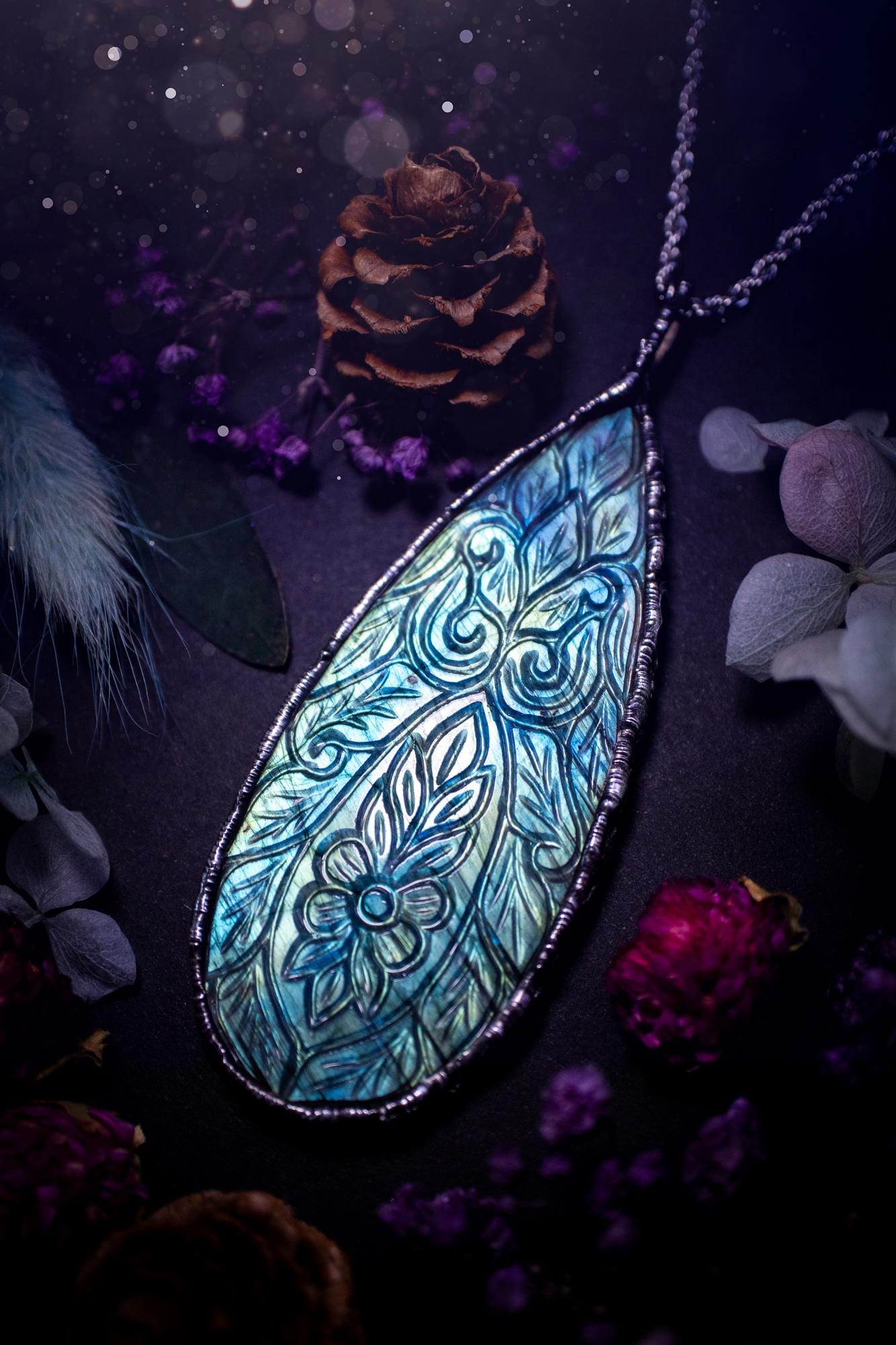 Beautifully handmade and bespoke, carved labradorite, soft soldered pendant necklace. This large labradorite pendant has been crafted using the soft solder method, also known as the tiffany technique. The crystal has a bezel of lead free soft solder which contains small parts of silver that allows for oxidisation and a high lustre polish. This labradorite is full of beautiful blues and greens and has been hand carved with a beautiful floral and leaf pattern. One off, gothic and witchy jewellery