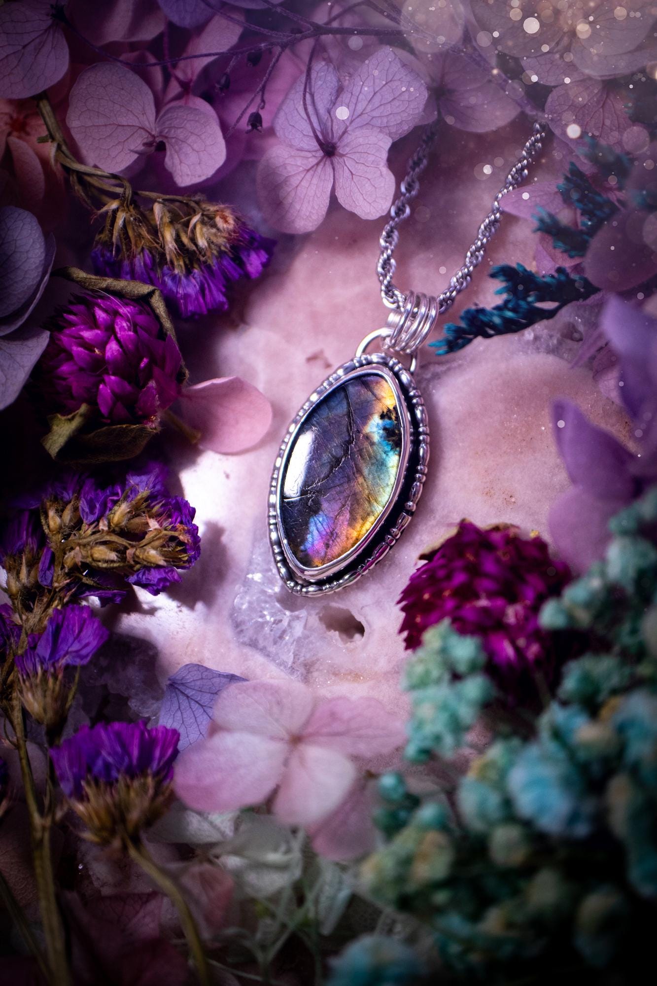 Beautifully handcrafted, rainbow labradorite crystal pendant necklace. This beautiful pendant has been crafted out of sterling and fine silver and features gothic bezel wire around the labradorite crystal. The labradorite in this piece is full of beautiful colours, purple, silvers, blues with a bit of orange! A really stunning crystal. This jewellery piece would be ideal for anyone who is a fan of jewellery and crystals, and would make the ideal gift. Full of witchy and gothic vibes!