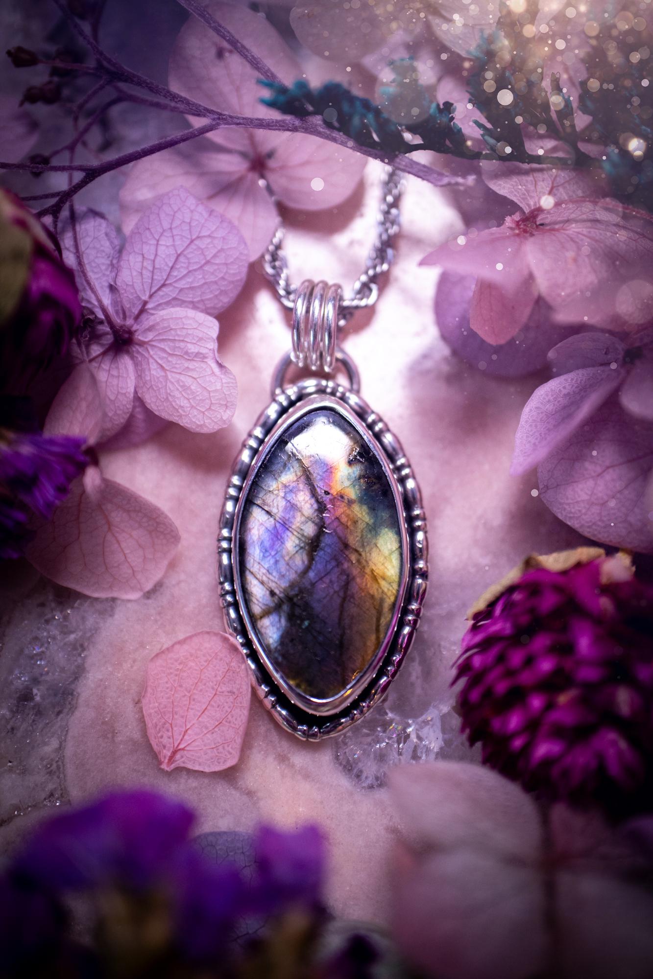 Beautifully handcrafted, rainbow labradorite crystal pendant necklace. This beautiful pendant has been crafted out of sterling and fine silver and features gothic bezel wire around the labradorite crystal. The labradorite in this piece is full of beautiful colours, purple, silvers, blues with a bit of orange! A really stunning crystal. This jewellery piece would be ideal for anyone who is a fan of jewellery and crystals, and would make the ideal gift. Full of witchy and gothic vibes!
