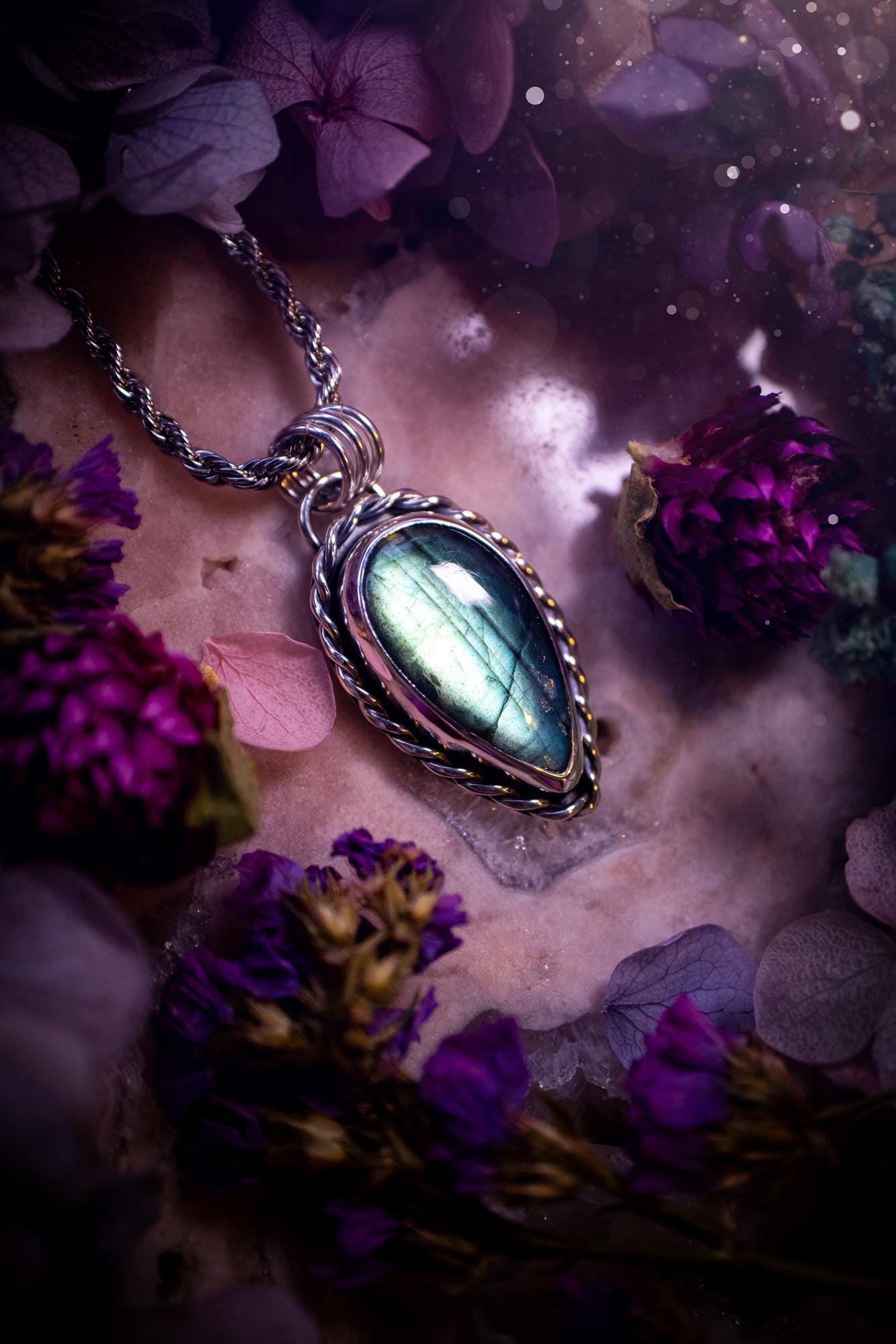 Beautifully handcrafted, nature green, flashy labradorite crystal pendant necklace. This beautiful pendant has been crafted out of sterling and fine silver and features gothic bezel wire around the labradorite crystal. The labradorite in this piece is full of beautiful green hues with a stunning pattern. A really beautiful crystal. This jewellery piece would be ideal for anyone who is a fan of jewellery and crystals, and would make the ideal gift. Full of witchy and gothic vibes!