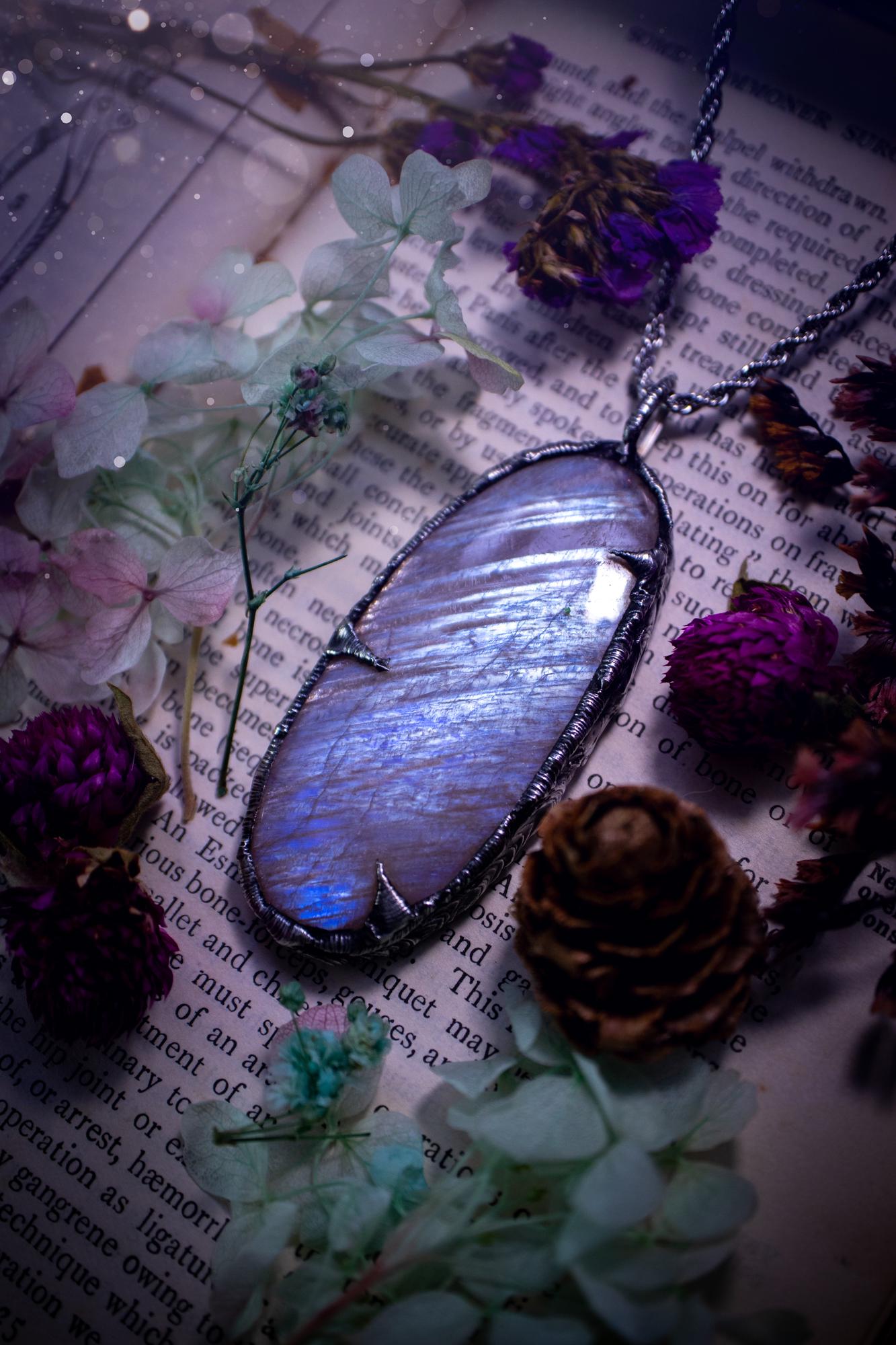 Handmade and beautiful, flashy belomorite, soft soldered pendant necklace. This pendant necklace features the most gorgeous and flashy belomorite moonstone crystal, full of glittery shimmer and a deep lovely blue hue. Handcrafted using the soft solder method, also known as the tiffany technique, an ancient technique used to created stained glass windows. The solder used is lead free and totally safe to wear, it contains elements of silver and polishes up to a high lustre. Gothic witchy jewellery