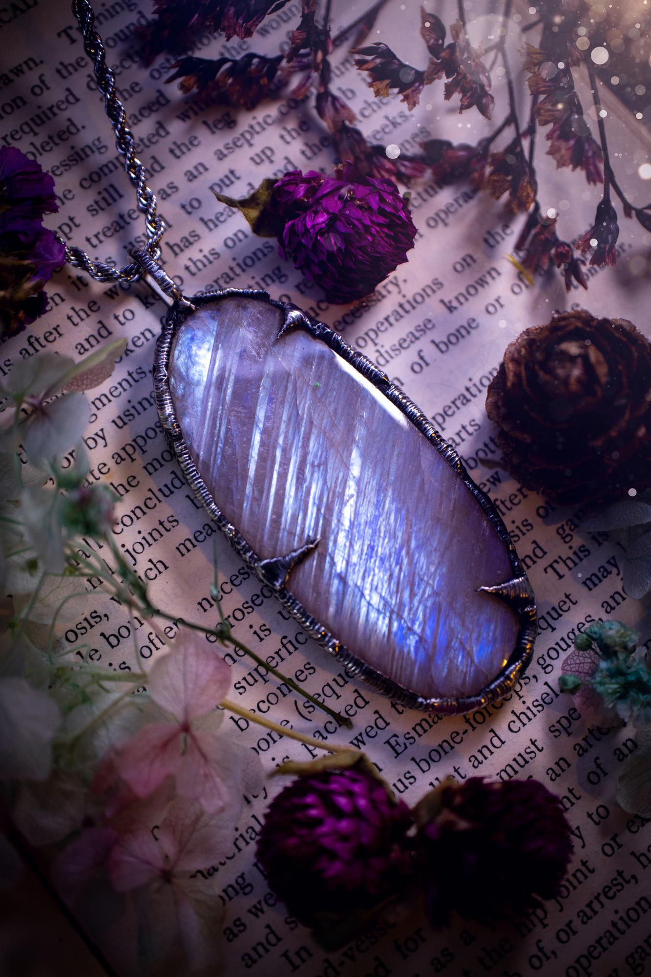 Handmade and beautiful, flashy belomorite, soft soldered pendant necklace. This pendant necklace features the most gorgeous and flashy belomorite moonstone crystal, full of glittery shimmer and a deep lovely blue hue. Handcrafted using the soft solder method, also known as the tiffany technique, an ancient technique used to created stained glass windows. The solder used is lead free and totally safe to wear, it contains elements of silver and polishes up to a high lustre. Gothic witchy jewellery