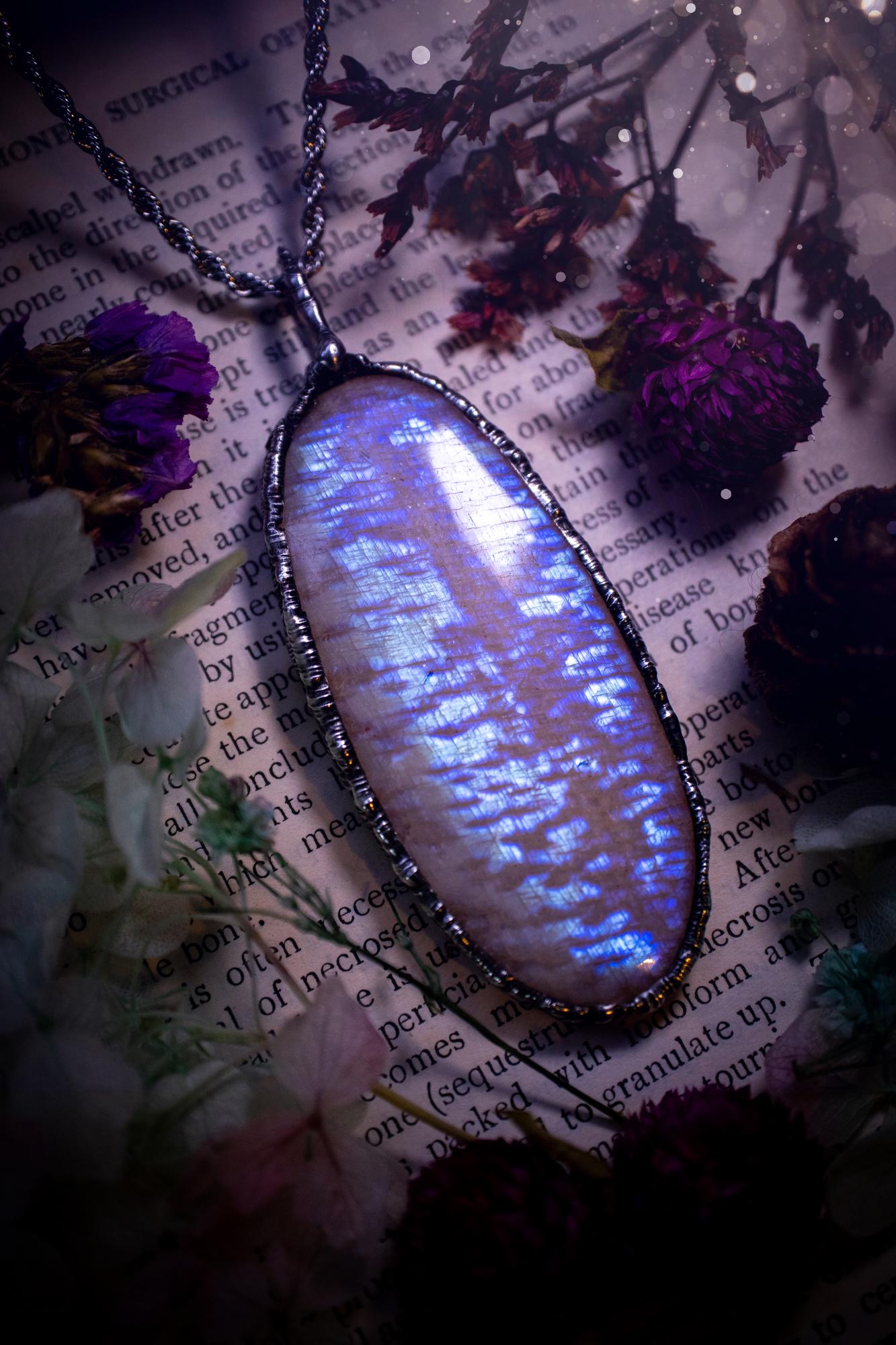 Handmade and beautiful, flashy belomorite, soft soldered pendant necklace. This pendant necklace features the most gorgeous and flashy belomorite moonstone crystal, full of glittery shimmer and a deep lovely blue hue. Handcrafted using the soft solder method, also known as the tiffany technique, an ancient technique used to created stained glass windows. The solder used is lead free and totally safe to wear, it contains elements of silver and polishes up to a high lustre. Gothic witchy jewellery