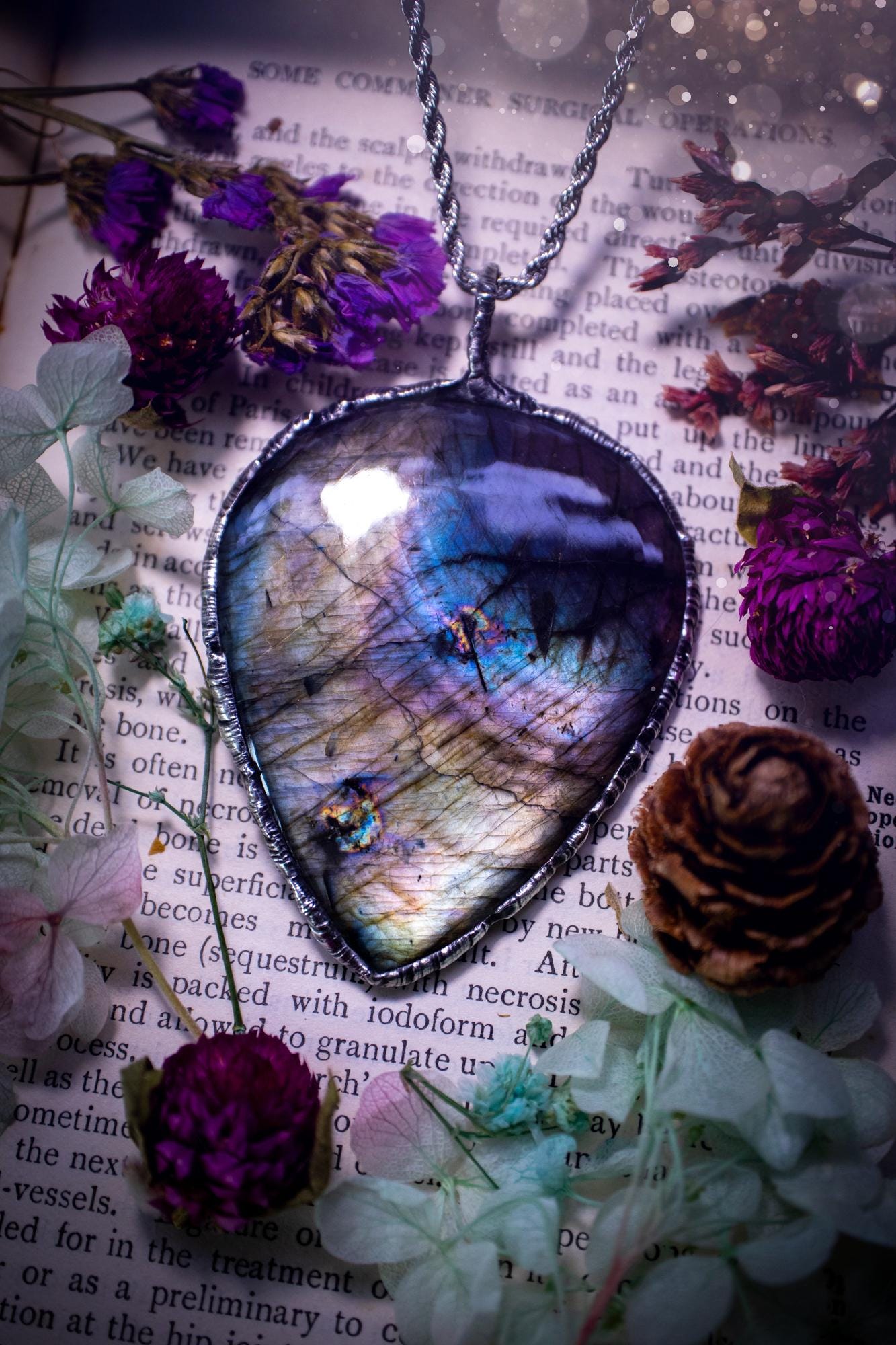A very unique and one of a kind, soft soldered, labradorite, statement pendant necklace. The labradorite on this pendant is very unique as it is full of silver, purples and blues, with little rainbow clusters. It also has two separate flashing areas on the crystal. Large and beautiful! Handmade using the soft solder method also known as the tiffany technique! This piece of jewellery is a must have for any crystal and jewellery lover, it is full of gothic and witchy vibes! Jewellery for the soul
