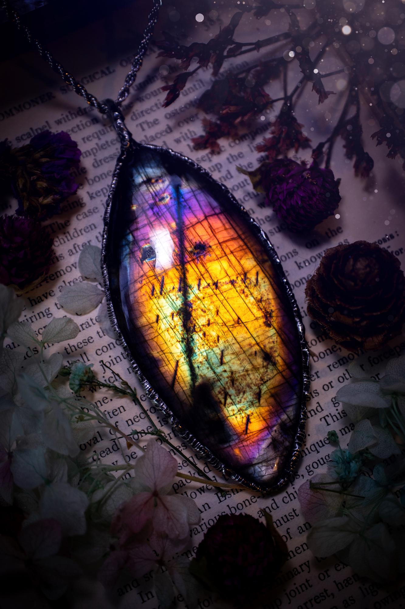 A very unique and one of a kind, soft soldered, labradorite, statement pendant necklace. The labradorite on this pendant is very unique as it is full of rainbow hues and is very large in size. Handmade using the soft solder method also known as the tiffany technique! This piece of jewellery is a must have for any crystal and jewellery lover, it is full of gothic and witchy vibes! Jewellery for the soul
