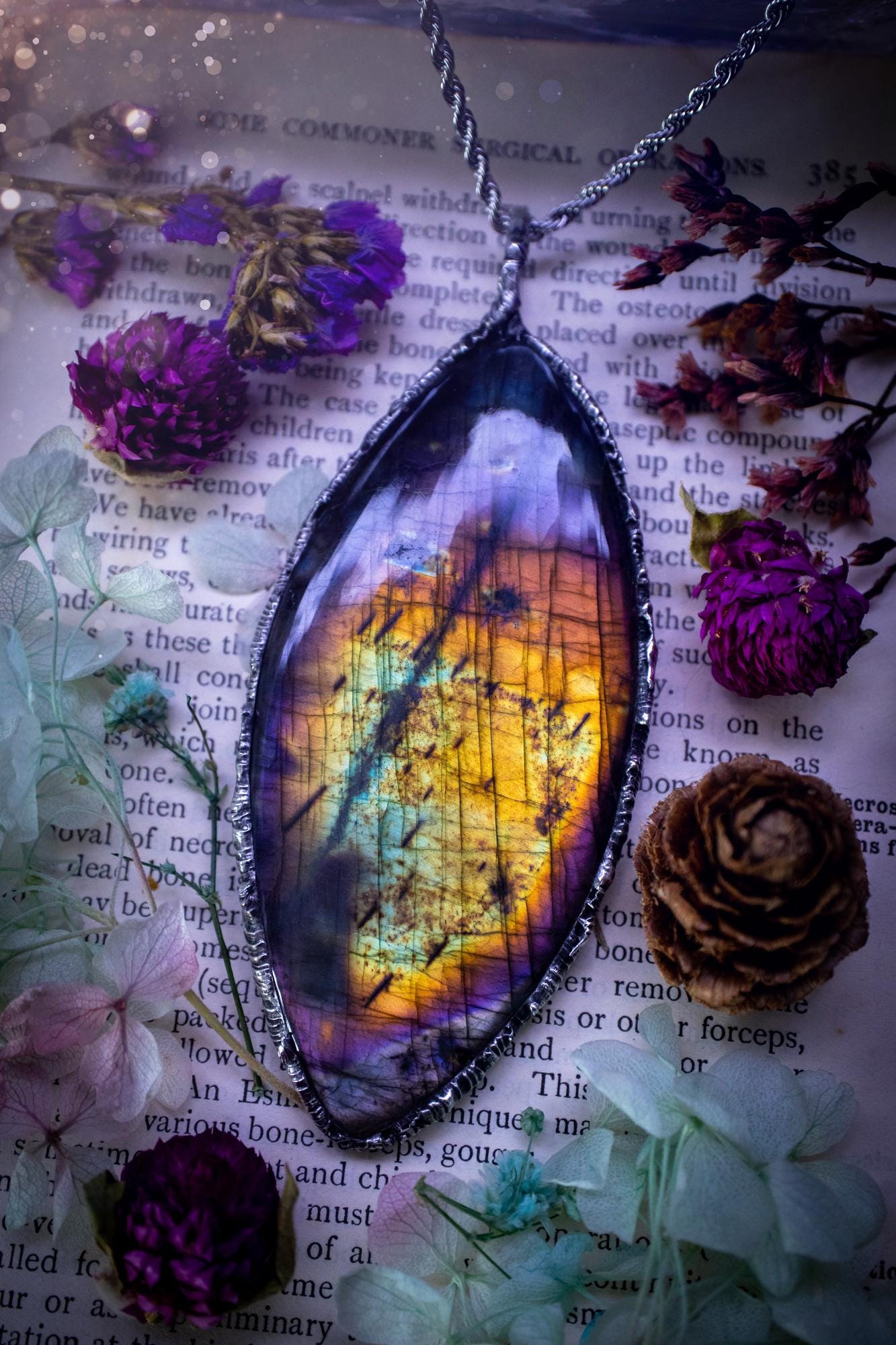 A very unique and one of a kind, soft soldered, labradorite, statement pendant necklace. The labradorite on this pendant is very unique as it is full of rainbow hues and is very large in size. Handmade using the soft solder method also known as the tiffany technique! This piece of jewellery is a must have for any crystal and jewellery lover, it is full of gothic and witchy vibes! Jewellery for the soul