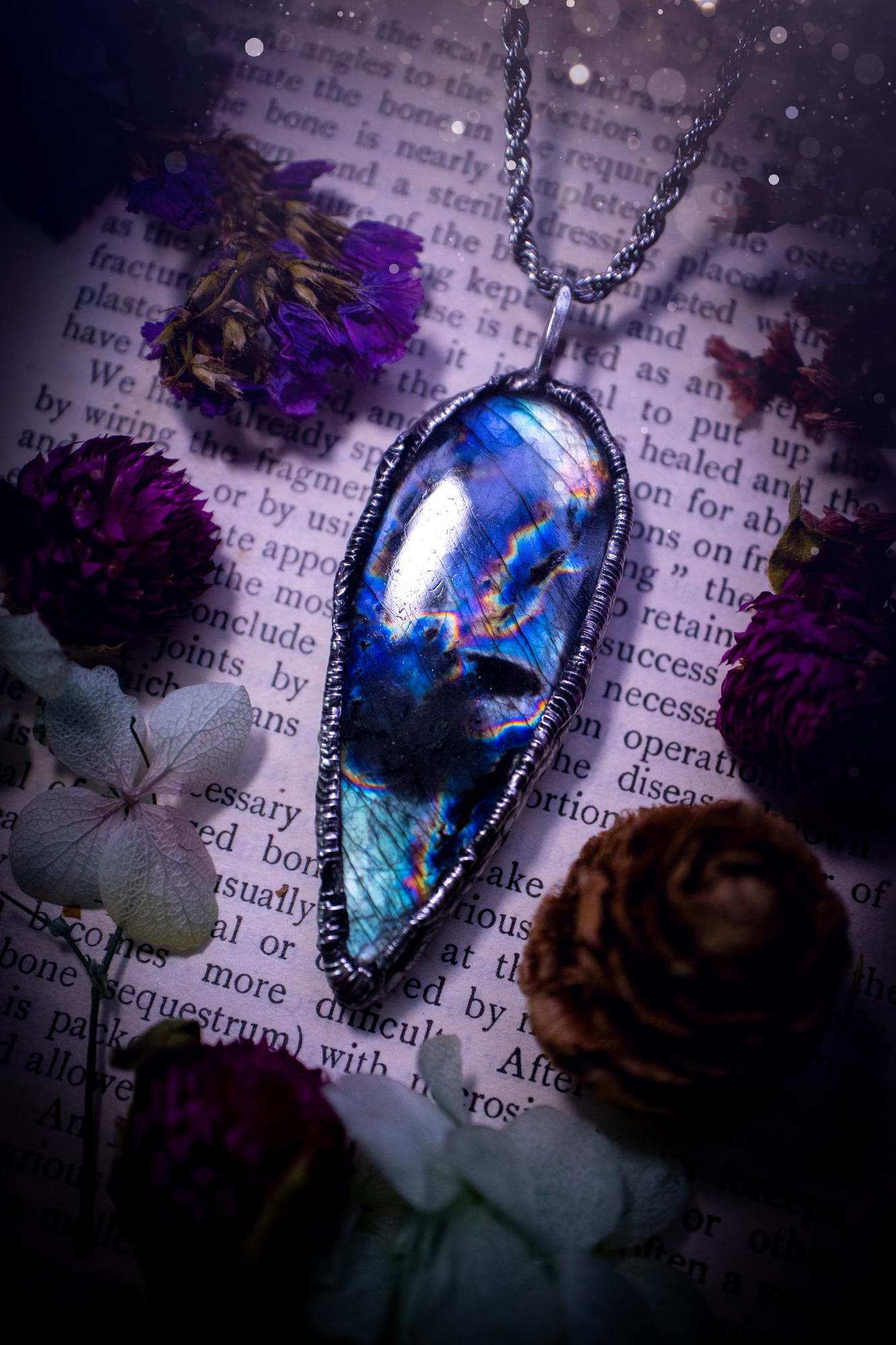 A very unique and one of a kind, soft soldered, labradorite, pendant necklace. The labradorite on this pendant is very unique as it is full of green, purples and blues, with little rainbow clusters. It also has two separate flashing areas on the crystal. Very vibrant and beautiful! Handmade using the soft solder method also known as the tiffany technique! This piece of jewellery is a must have for any crystal and jewellery lover, it is full of gothic and witchy vibes! Jewellery for the soul