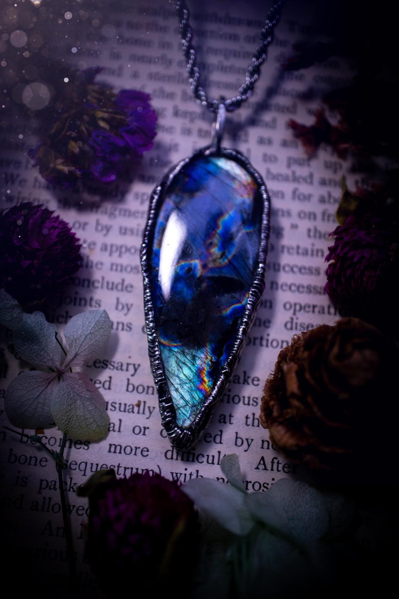 A very unique and one of a kind, soft soldered, labradorite, pendant necklace. The labradorite on this pendant is very unique as it is full of green, purples and blues, with little rainbow clusters. It also has two separate flashing areas on the crystal. Very vibrant and beautiful! Handmade using the soft solder method also known as the tiffany technique! This piece of jewellery is a must have for any crystal and jewellery lover, it is full of gothic and witchy vibes! Jewellery for the soul