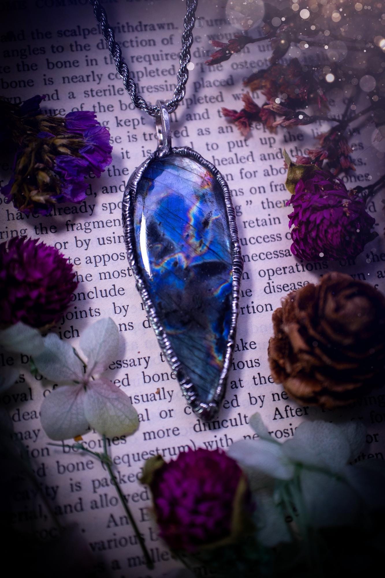 A very unique and one of a kind, soft soldered, labradorite, pendant necklace. The labradorite on this pendant is very unique as it is full of green, purples and blues, with little rainbow clusters. It also has two separate flashing areas on the crystal. Very vibrant and beautiful! Handmade using the soft solder method also known as the tiffany technique! This piece of jewellery is a must have for any crystal and jewellery lover, it is full of gothic and witchy vibes! Jewellery for the soul