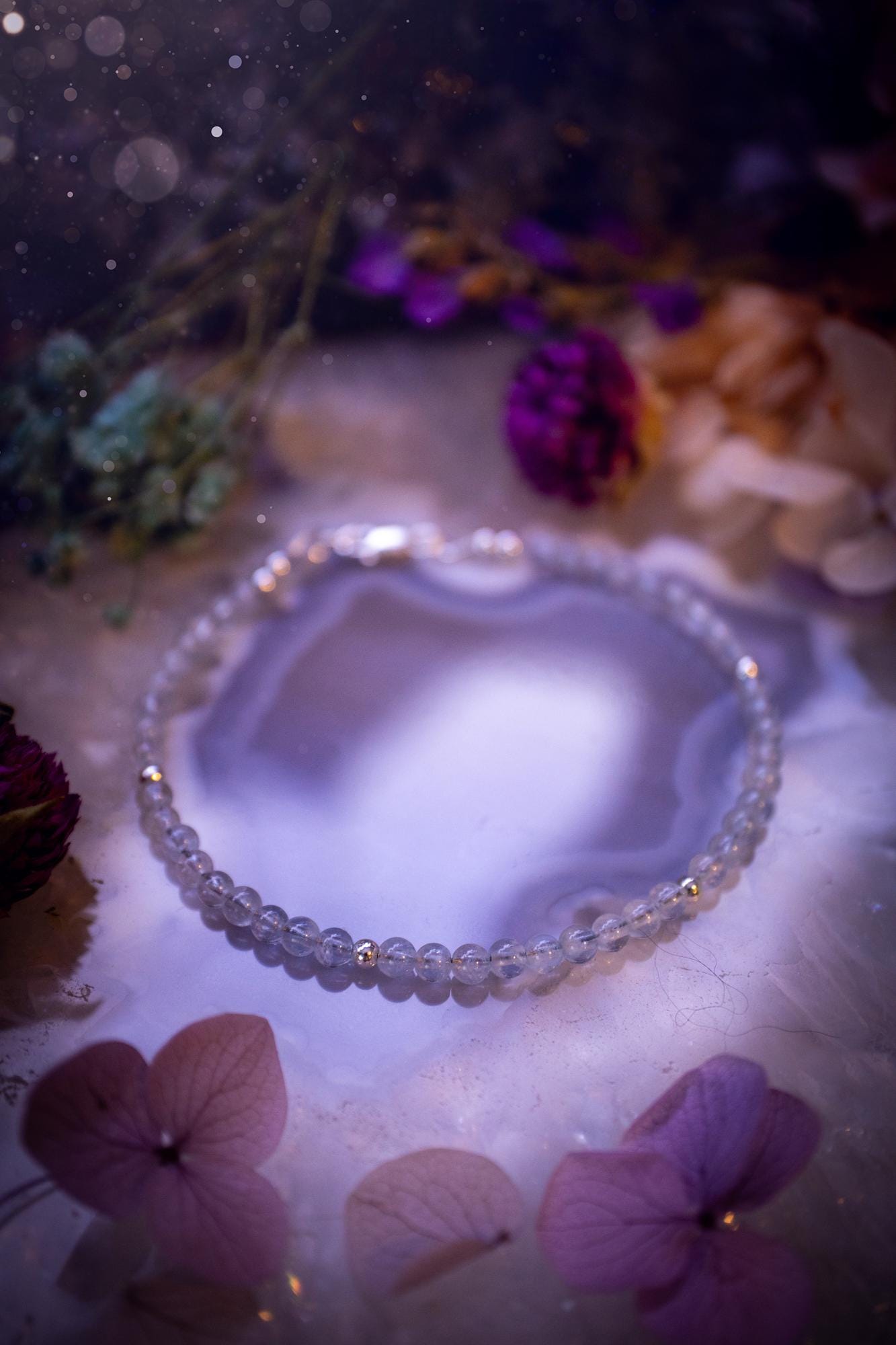 Beautifully handmade, and customisable, high grade aquamarine crystal bead, stacking bracelet. This dainty crystal bracelet features high grade, genuine, smooth, aquamarine crystal beads which give off a beautiful shimmer. Strung on 49 strand beading wire with a choice of customisable findings to suit your style. Ideal for gifting, and suitable for any crystal and jewellery lover. Celestial, witchy and gothic.