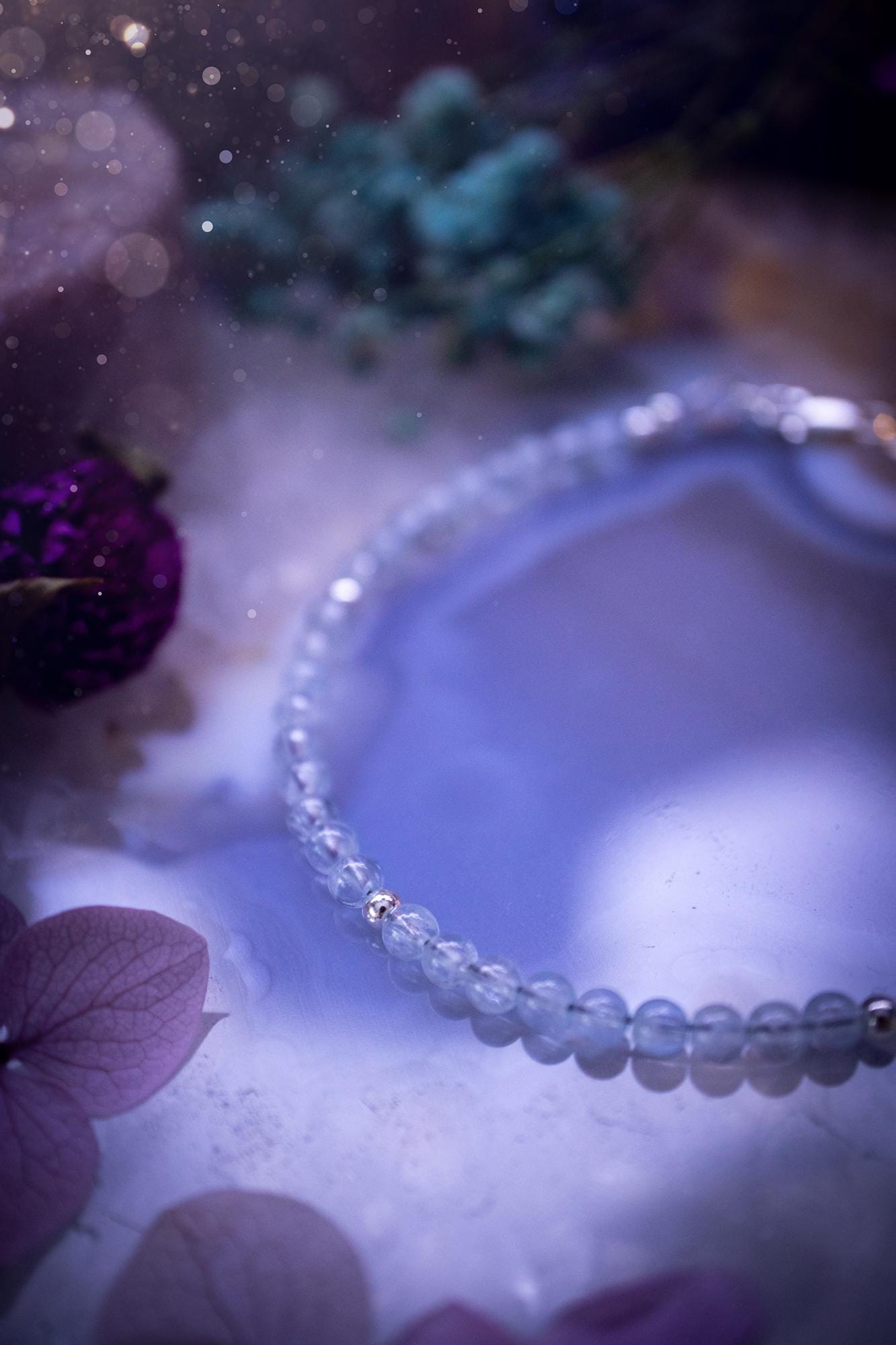 Beautifully handmade, and customisable, high grade aquamarine crystal bead, stacking bracelet. This dainty crystal bracelet features high grade, genuine, smooth, aquamarine crystal beads which give off a beautiful shimmer. Strung on 49 strand beading wire with a choice of customisable findings to suit your style. Ideal for gifting, and suitable for any crystal and jewellery lover. Celestial, witchy and gothic.