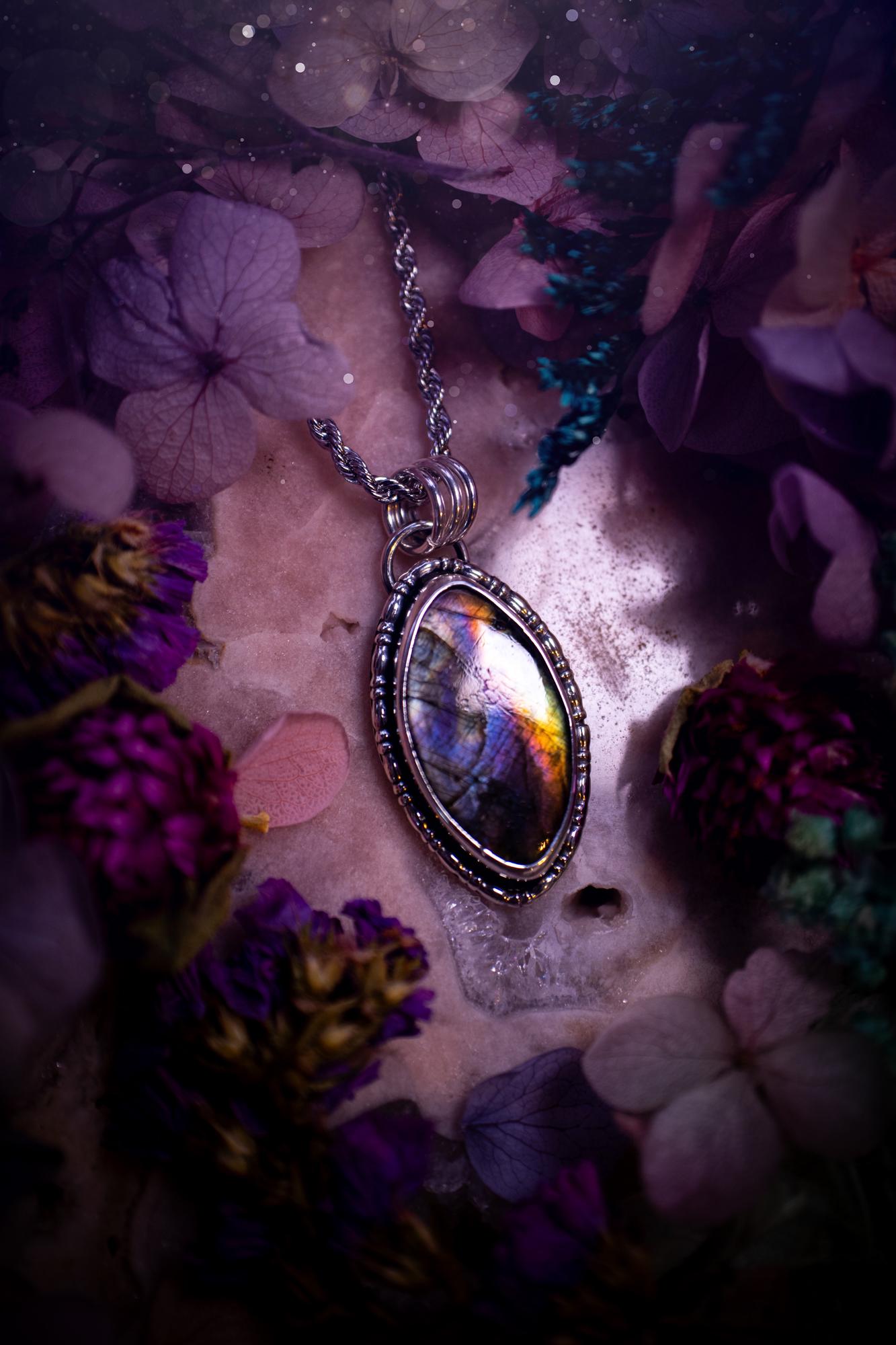 Beautifully handcrafted, rainbow labradorite crystal pendant necklace. This beautiful pendant has been crafted out of sterling and fine silver and features gothic bezel wire around the labradorite crystal. The labradorite in this piece is full of beautiful colours, purple, silvers, blues with a bit of orange! A really stunning crystal. This jewellery piece would be ideal for anyone who is a fan of jewellery and crystals, and would make the ideal gift. Full of witchy and gothic vibes!