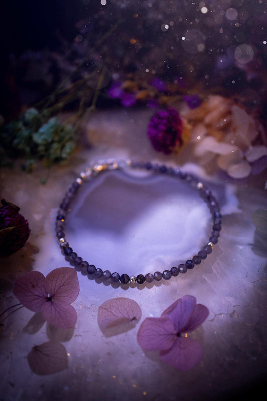 Beautifully handmade, and customisable, iolite crystal bead, stacking bracelet. This dainty crystal bracelet features high grade, genuine, rose cut, iolite crystal beads which give off a beautiful sparkle. They are a lovely purple and blue hue full of vibrancy. Strung on 49 strand beading wire with a choice of customisable findings to suit your style. Ideal for gifting, and suitable for any crystal and jewellery lover. Celestial, witchy and gothic.