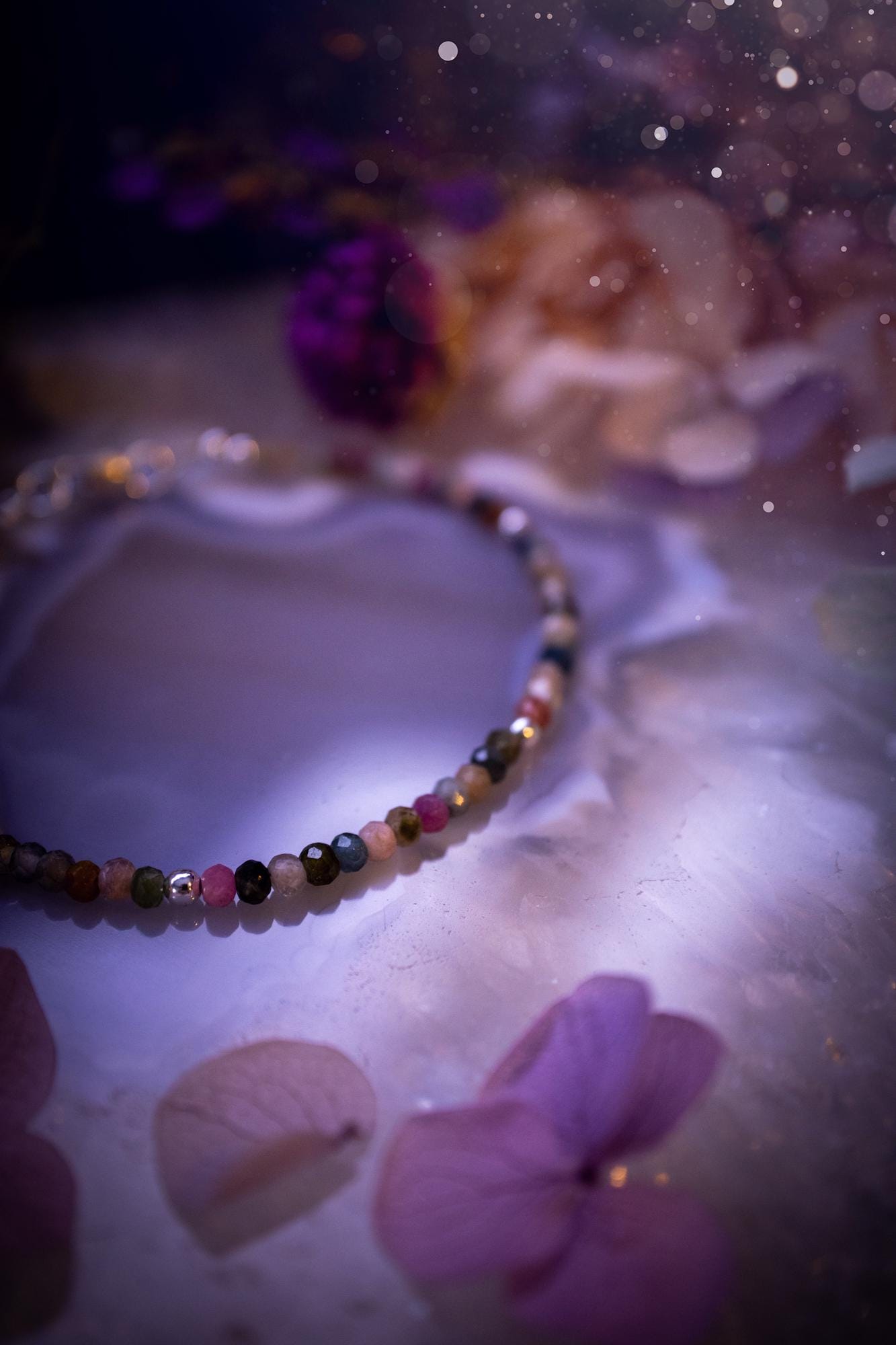 Beautifully handmade, and customisable, mixed tourmaline crystal bead, stacking bracelet. This dainty crystal bracelet features high grade, genuine, rose cut, tourmaline crystal beads which give off a beautiful sparkle. They are a lovely mix of hue, full of vibrancy. Strung on 49 strand beading wire with a choice of customisable findings to suit your style. Ideal for gifting, and suitable for any crystal and jewellery lover. Celestial, witchy and gothic.