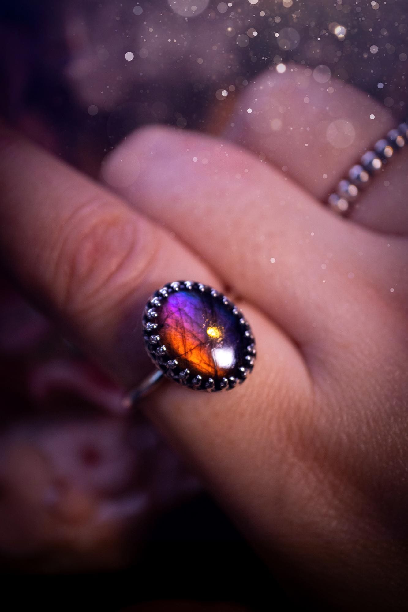 Handmade and very gothic, natural purple labradorite, sterling silver ring. This minimalist ring features a very pretty and flashy labradorite crystal that has a rich and vibrant purple colour. Around the crystal is a beautifully detail, gothic bezel that has been polished to a high lustre. The crystal is mounted on a 1.50mm ring shank. This ring would be ideal for anyone who loves jewellery and crystals, or who has a gothic and witchy style. A beautiful piece of jewellery to add to a collection