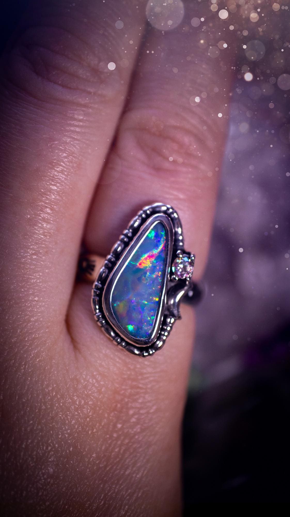 Handmade and totally bespoke, Australian Opal doublet, celestial style ring. This mini statement ring has been handmade using fine and sterling silver. Featuring a very beautiful and bold Australian Opal doublet that is full of colour play with lilac, reds, blues and greens that are super flashy! The ring is of a celestial style with a little moon and aurora coloured cubic zirconia to the side. This little ring would be suitable for anyone who loves crystals, opals and jewellery! Gothic vibes