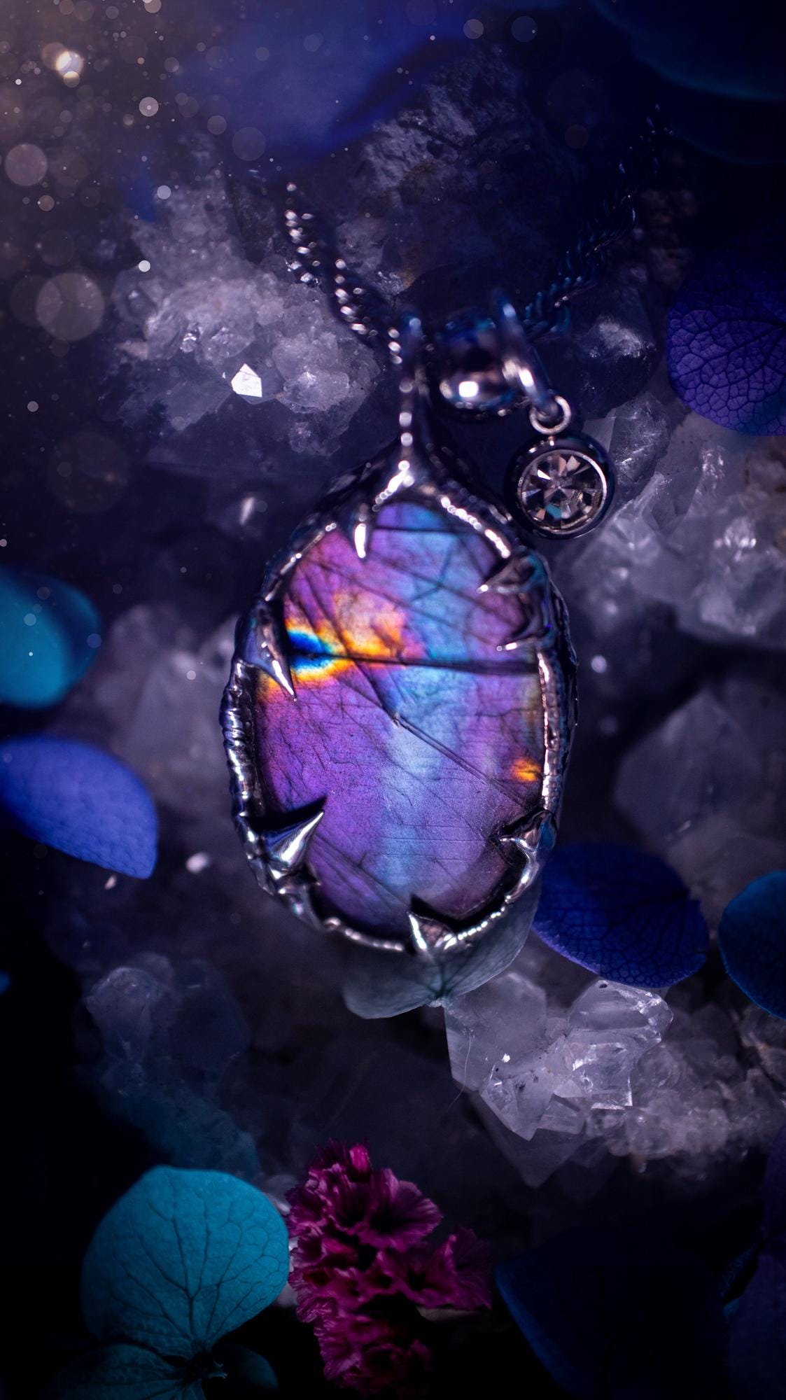 Beautifully handmade and bespoke, purple labradorite, soft soldered pendant necklace. This dainty labradorite pendant has been crafted using the soft solder method, also known as the tiffany technique. The crystal has a bezel of lead free soft solder which contains small parts of silver that allows for oxidisation and a high lustre polish. This labradorite is full of beautiful pinks, purples and has a lovely flash. One off, gothic and witchy jewellery with little claws on the bezel.