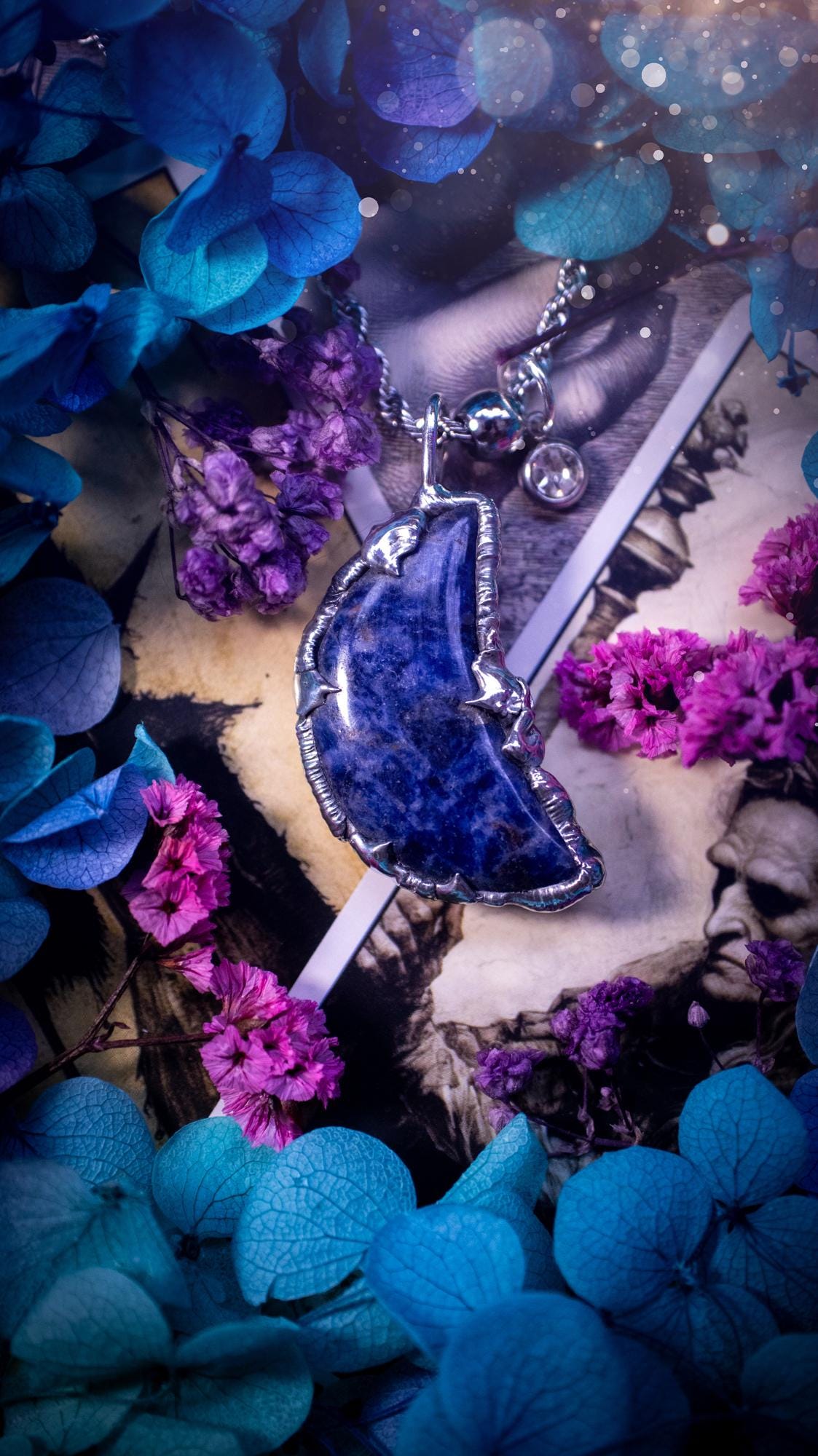 Beautifully bespoke and handcrafted, sodalite, soft soldered moon pendant necklace. This necklace has been handmade using the soft solder method with lead free solder with mix metals including silver. Featuring a gorgeous sodalite moon with stunning patterns. This piece is very unique and comes with its own little cubic zirconia charm. This pendant necklace would be suitable for anyone who loves crystals and jewellery, and that also loves a gothic and witchy vibe! Total soul jewellery