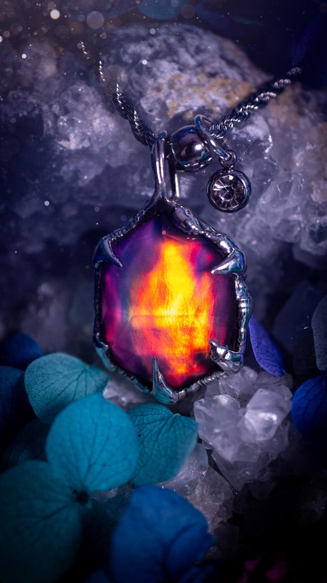 A beautiful, one of a kind, aurora opal pendant necklace. This little statement necklace is handmade using the tiffany technique, also known as soft soldering. Featuring the most stunning, and sparkly aurora opal which is full of pinks, greens and blues just like the northern lights. Aurora opals are man made opals that look similar to natural ones, they have a layer of rose quartz on top to give extra shine. The ideal gift for any crystal or jewellery lover. Gothic and witchy jewellery