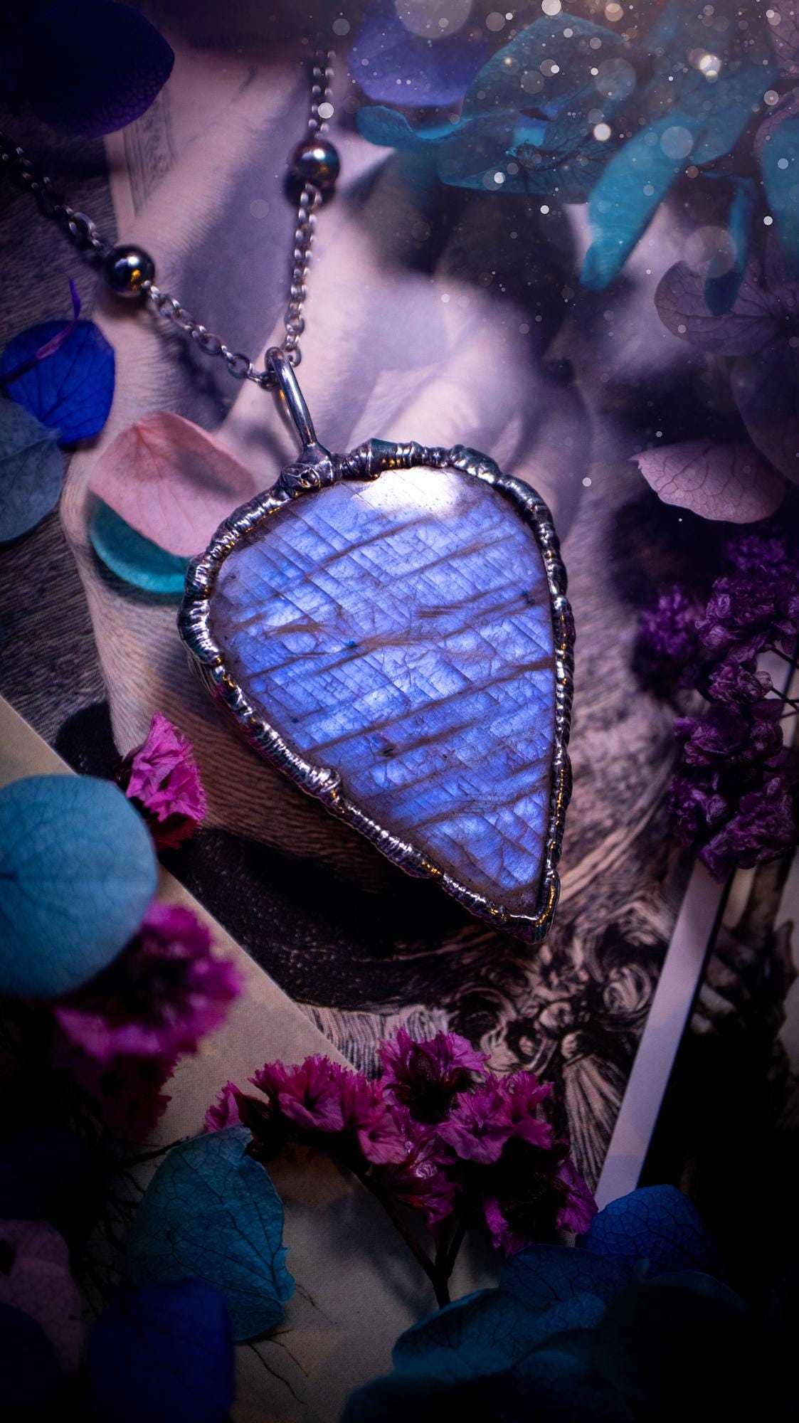 Handmade and beautiful, flashy belomorite, soft soldered pendant necklace. This pendant necklace features the most gorgeous and flashy belomorite moonstone crystal, full of glittery shimmer and a deep lovely blue hue. Handcrafted using the soft solder method, also known as the tiffany technique, an ancient technique used to created stained glass windows. The solder used is lead free and totally safe to wear, it contains elements of silver and polishes up to a high lustre. Gothic witchy jewellery