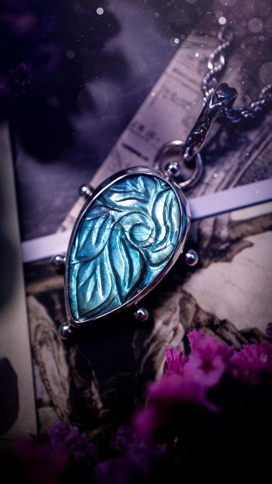 Beautifully handmade, green and blue, hand carved, labradorite crystal pendant necklace. This one of a kind necklace features a beautiful, flashy blue and green labradorite that has a hand carved pattern on its surface. Handcrafted using a mix of fine and sterling silver, with pretty little ball accents and a stamped bail. This cute little piece is ideal for anyone who loves crystals and jewellery. A one off piece with no other being the same, ideal for gifting for any occasion.