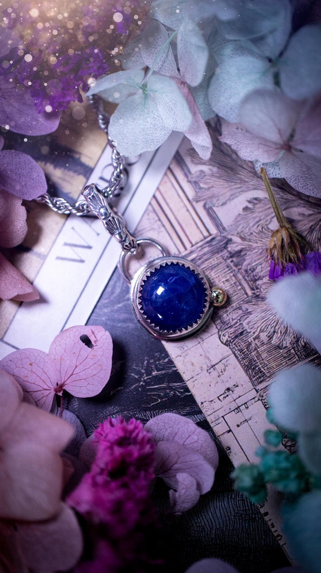Handmade tanzanite pendant set in sterling silver with a high polished finish. The natural tanzanite gemstone displays rich blue violet tones with beautiful depth and shimmer in the light. Finished with a polished brass golden ball accent and a decorative patterned bail. Bohemian, gothic and witchy style crystal jewellery, perfect as a meaningful gift or elegant everyday statement piece. Tanzanite is the birthstone for December.