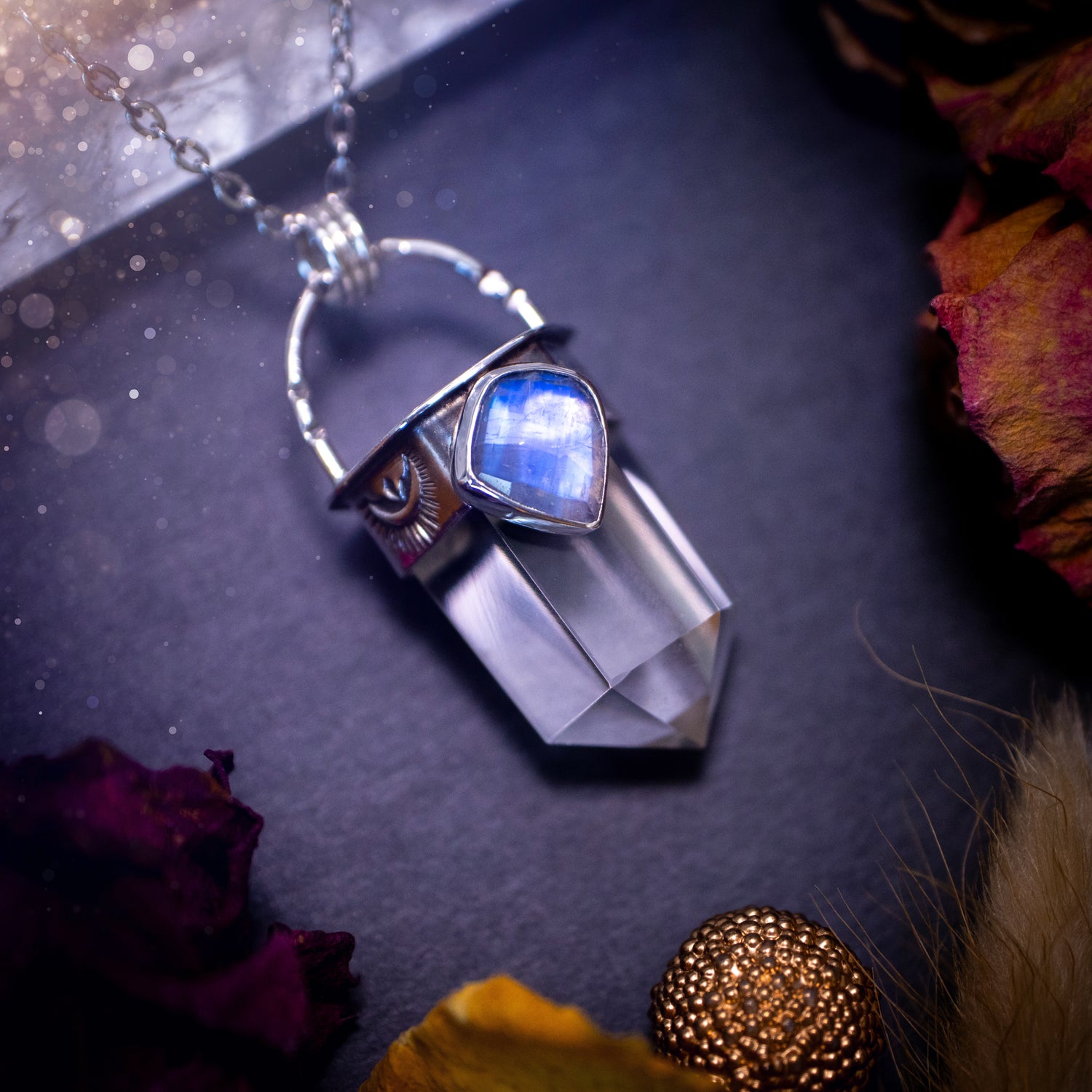 Crystal Quartz point pendant with rainbow moonstone on bezel. Made from fine and sterling silver. Handcrafted with love and care a unique piece of jewellery