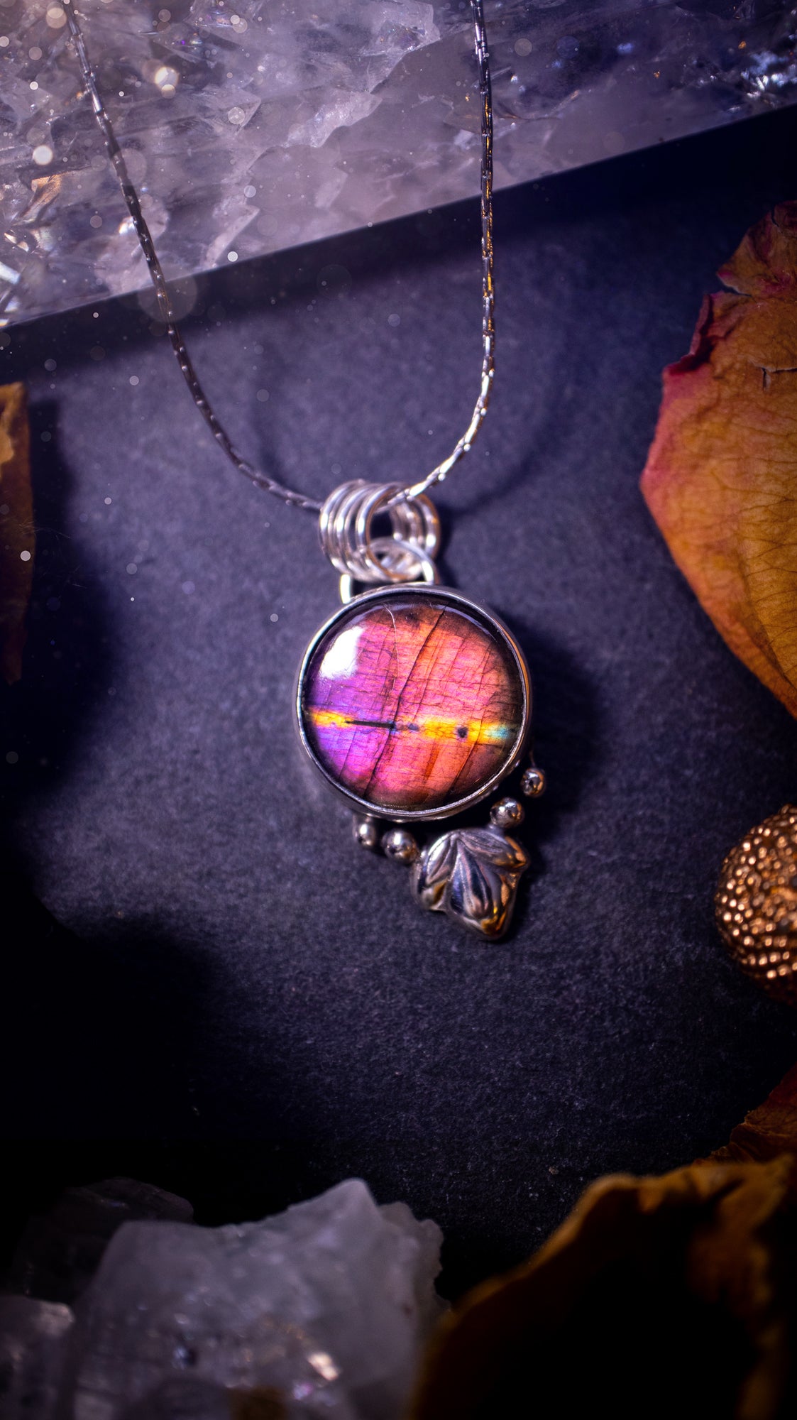 Gorgeous and handmade, sterling silver, purple and orange, labradorite spectrolite pendant necklace. This beautiful necklace features a beautiful labradorite crystal full of colour. Handcrafted from sterling silver that has been recycled. Ideal gift.