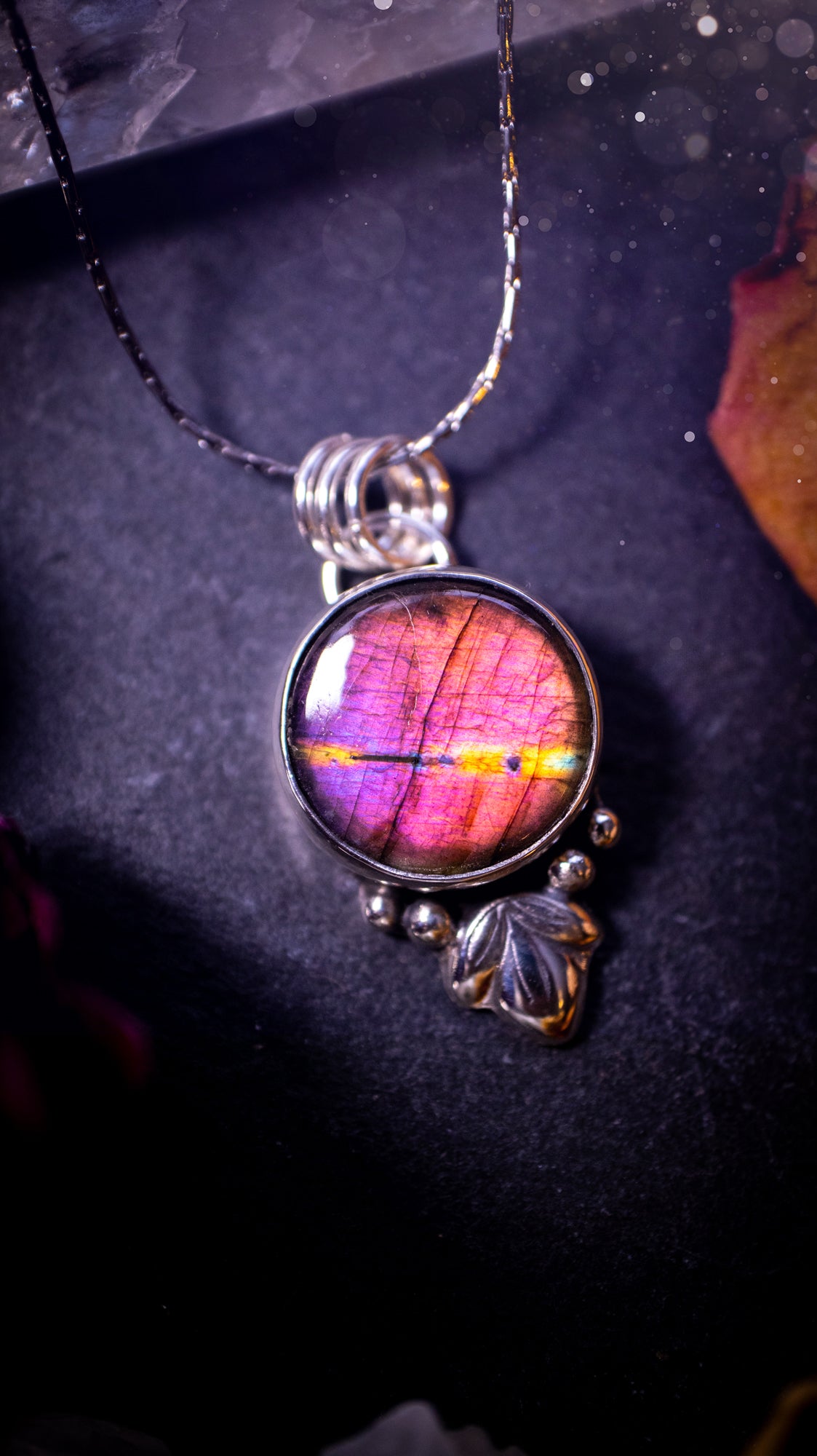 Gorgeous and handmade, sterling silver, purple and orange, labradorite spectrolite pendant necklace. This beautiful necklace features a beautiful labradorite crystal full of colour. Handcrafted from sterling silver that has been recycled. Ideal gift.