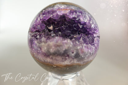 Beautiful, real natural crystal, amethyst cluster sphere. This crystal amethyst is truly gorgeous, featuring deep tone of purple amongst the clusters that are within this sphere. A beautiful piece to add to any crystal collection. Ideal for meditation and healing. 