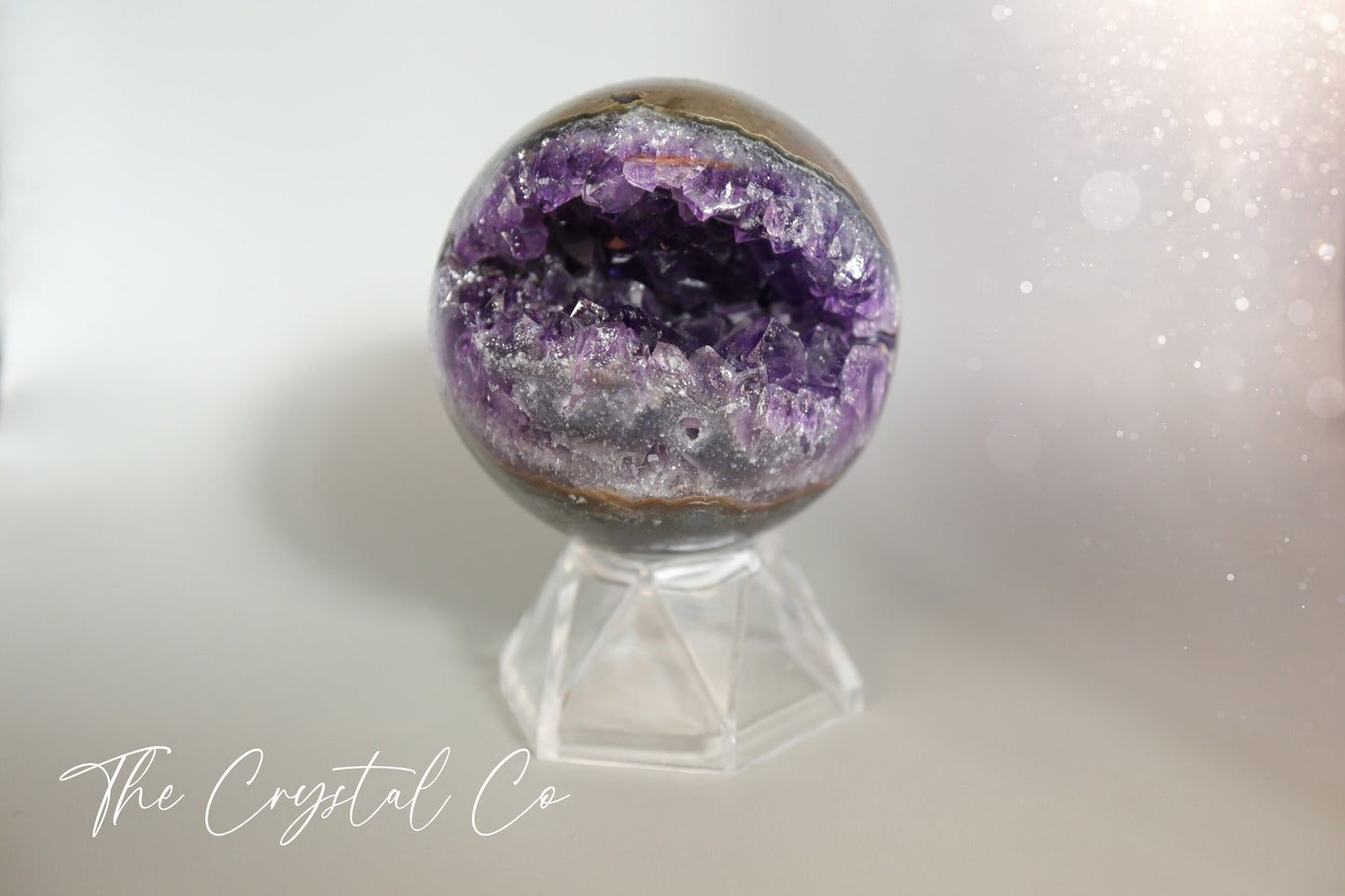 Beautiful, real natural crystal, amethyst cluster sphere. This crystal amethyst is truly gorgeous, featuring deep tone of purple amongst the clusters that are within this sphere. A beautiful piece to add to any crystal collection. Ideal for meditation and healing. 