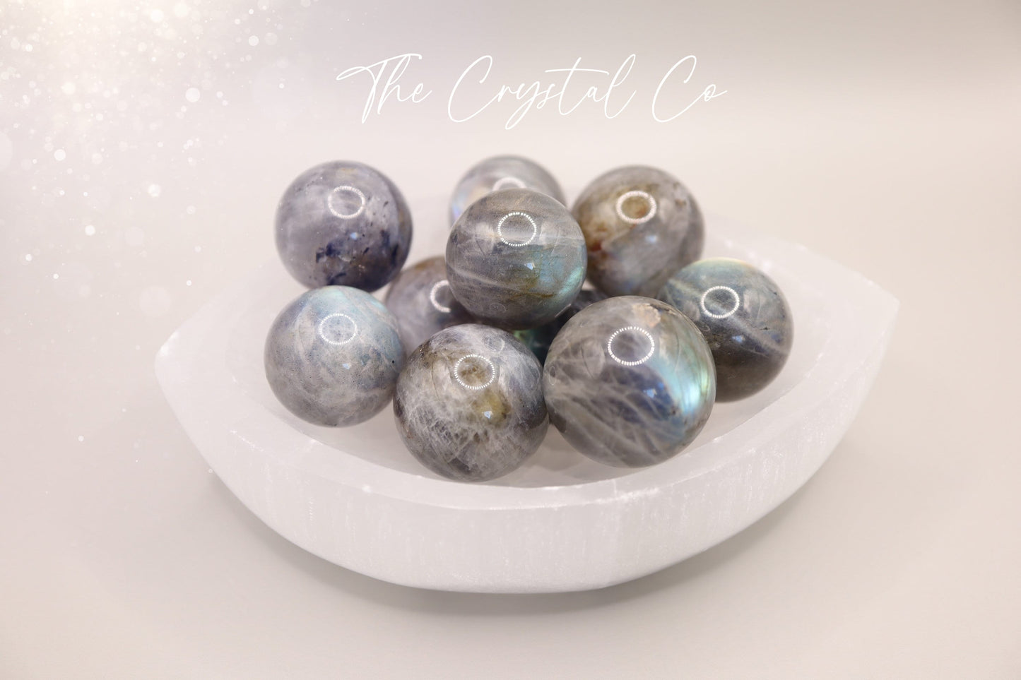 Mini natural labradorite spheres with a flashy iridescent sheen, perfect as pocket crystals or display. Each sphere showcases flashes of blue, green, or gold tones. Hand-polished and sized to fit in the palm, ideal for crystal collectors or gifting