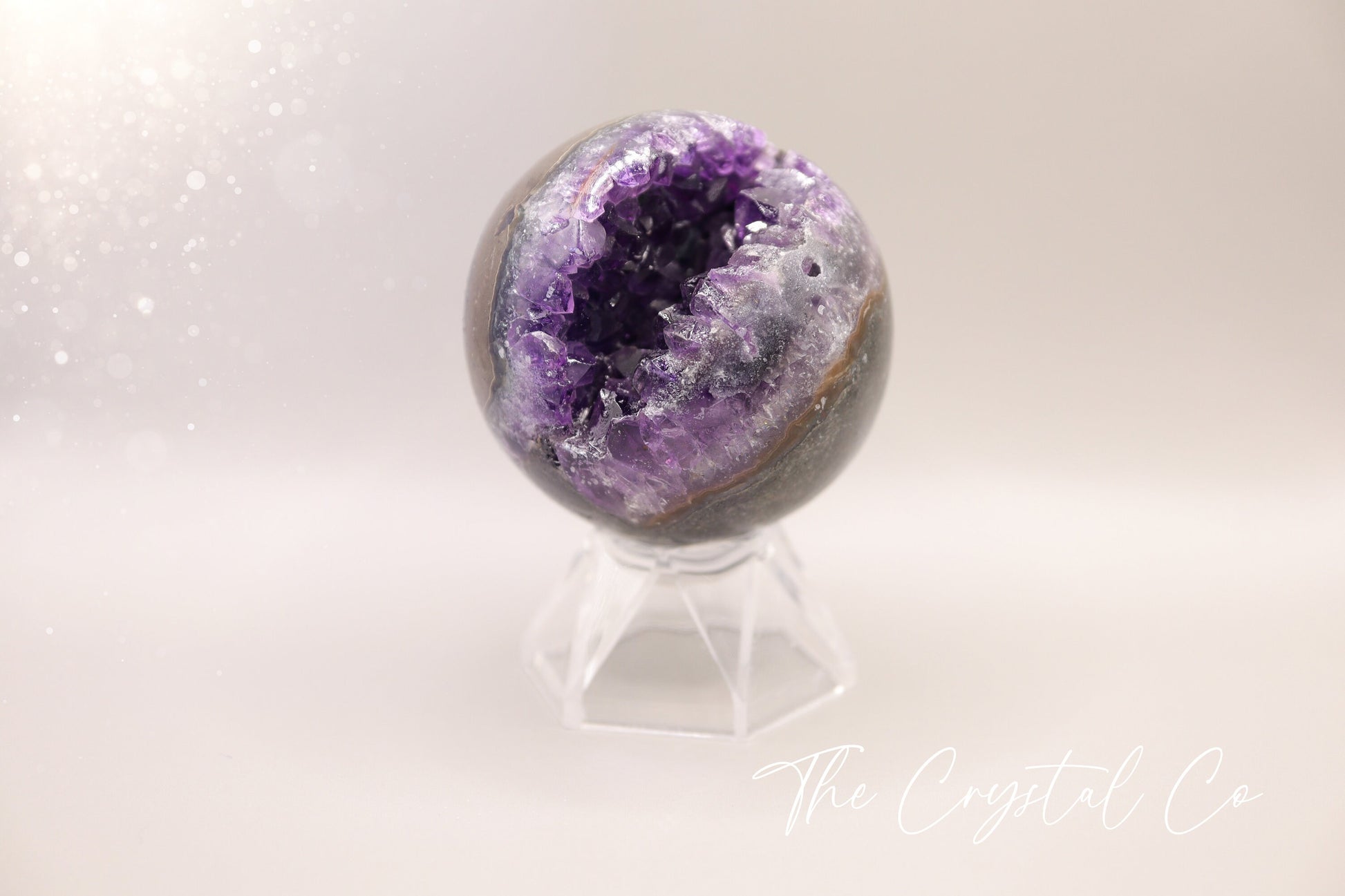 Beautiful, real natural crystal, amethyst cluster sphere. This crystal amethyst is truly gorgeous, featuring deep tone of purple amongst the clusters that are within this sphere. A beautiful piece to add to any crystal collection. Ideal for meditation and healing. 