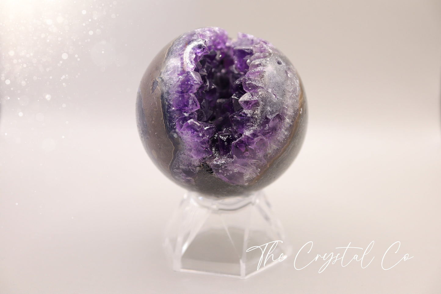 Beautiful, real natural crystal, amethyst cluster sphere. This crystal amethyst is truly gorgeous, featuring deep tone of purple amongst the clusters that are within this sphere. A beautiful piece to add to any crystal collection. Ideal for meditation and healing. 