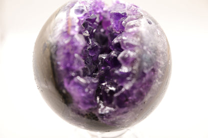 Beautiful, real natural crystal, amethyst cluster sphere. This crystal amethyst is truly gorgeous, featuring deep tone of purple amongst the clusters that are within this sphere. A beautiful piece to add to any crystal collection. Ideal for meditation and healing. 