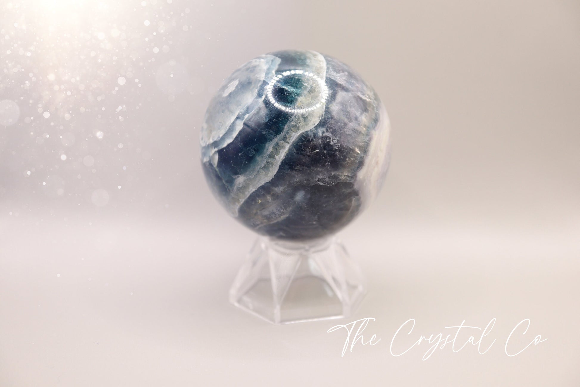 Beautiful real natural crystal, fluorite Sphere. Sizing comes in at 5.9 cm circumference. Weighs 339 grams. Full of beautiful colours and patterns, also has some beautiful rainbows within and feathers. Suitable for meditation, special occasions and gifts. This piece would make the ideal gift for a crystal lover.