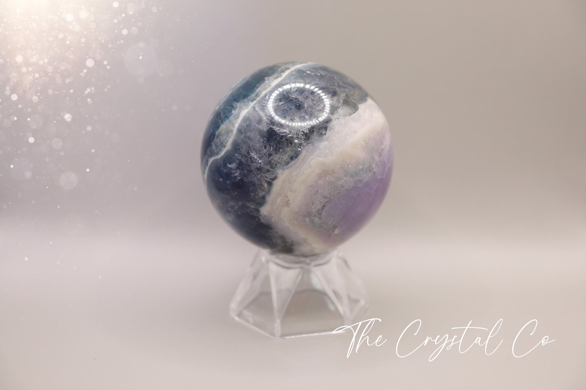 Beautiful real natural crystal, fluorite Sphere. Sizing comes in at 5.9 cm circumference. Weighs 339 grams. Full of beautiful colours and patterns, also has some beautiful rainbows within and feathers. Suitable for meditation, special occasions and gifts. This piece would make the ideal gift for a crystal lover.