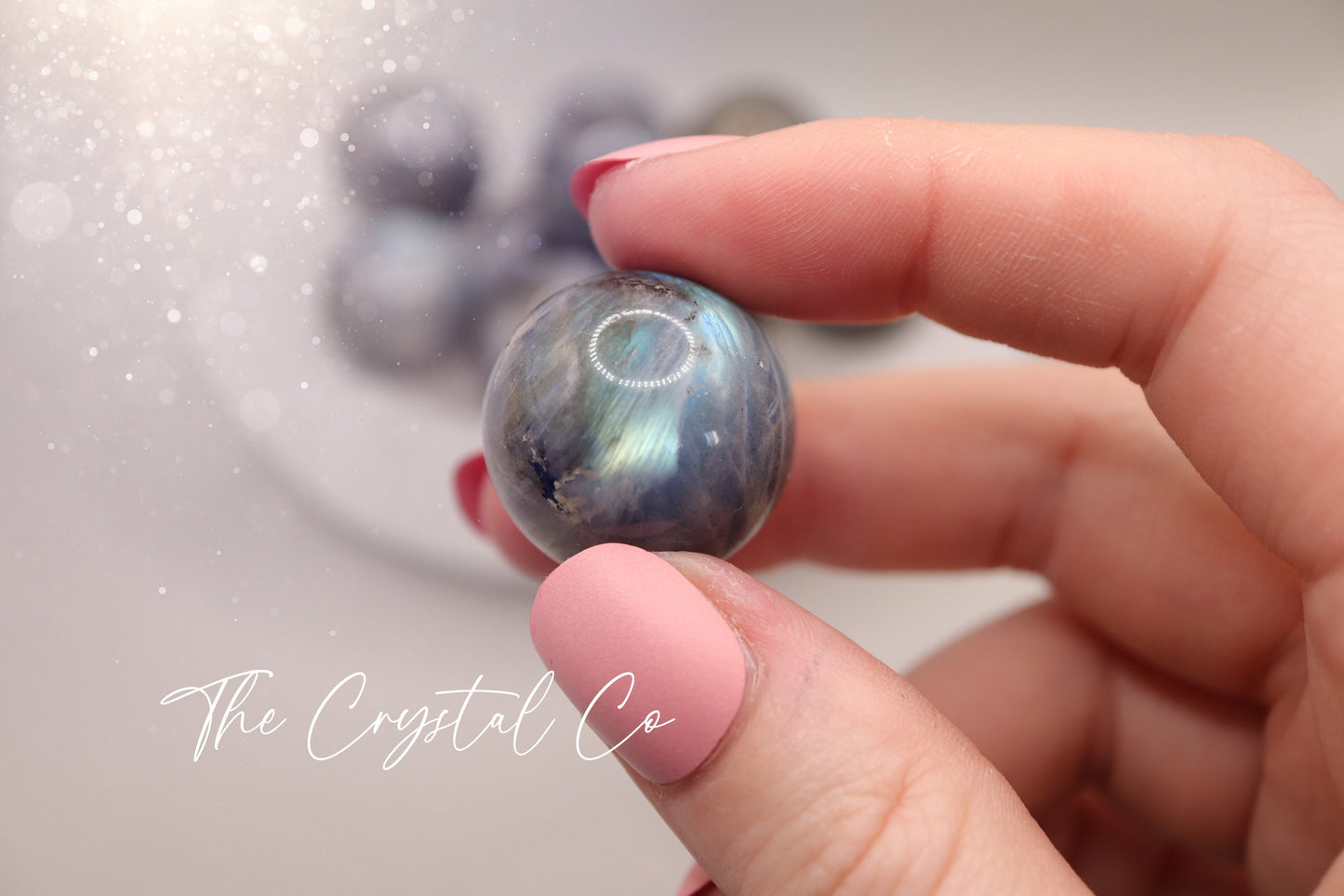 Mini natural labradorite spheres with a flashy iridescent sheen, perfect as pocket crystals or display. Each sphere showcases flashes of blue, green, or gold tones. Hand-polished and sized to fit in the palm, ideal for crystal collectors or gifting