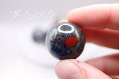 Beautiful, African Bloodstone small and medium pocket spheres. Full of beautiful red speckles, and gorgeous patterns. Some have little inclusions of Pyrite. Ideal as pocket crystals, meditation, and healing. Perfect as little gifts for crystal lovers.