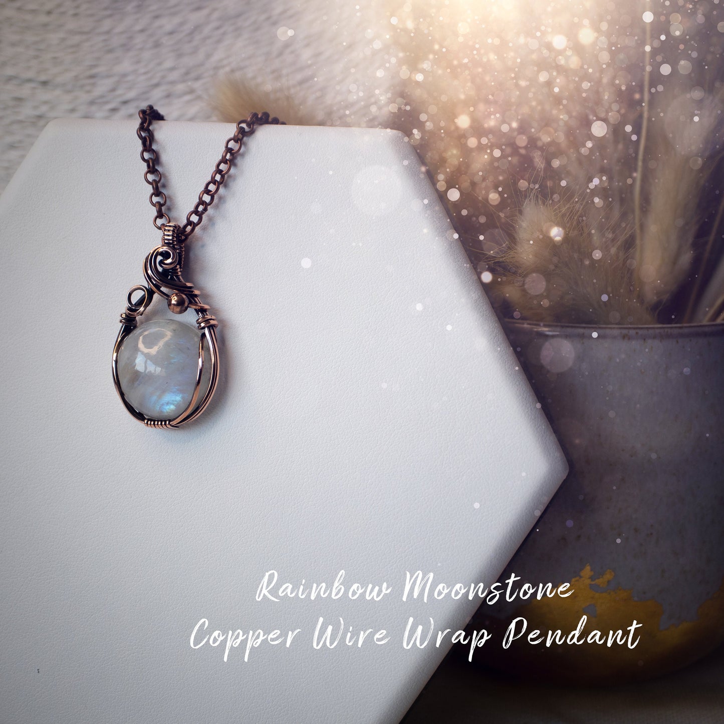 This is a one of a kind, handmade copper wire wrap pendant which features a natural flashy rainbow moonstone crystal. The rainbow moonstone crystal has a beautiful blue flash from different angles and compliments the highly polished, antiqued copper wire which shines luxury! Ideal gift for special occasions