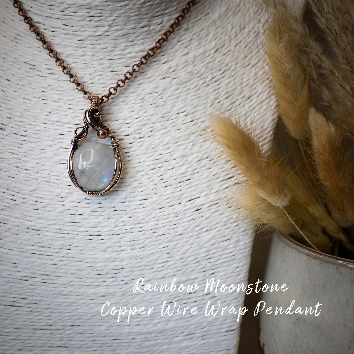 This is a one of a kind, handmade copper wire wrap pendant which features a natural flashy rainbow moonstone crystal. The rainbow moonstone crystal has a beautiful blue flash from different angles and compliments the highly polished, antiqued copper wire which shines luxury! Ideal gift for special occasions