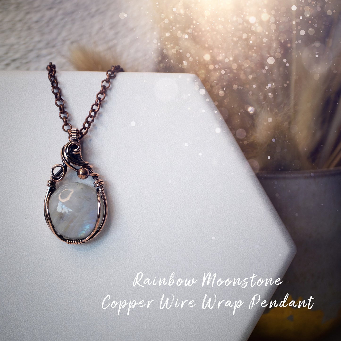 This is a one of a kind, handmade copper wire wrap pendant which features a natural flashy rainbow moonstone crystal. The rainbow moonstone crystal has a beautiful blue flash from different angles and compliments the highly polished, antiqued copper wire which shines luxury! Ideal gift for special occasions