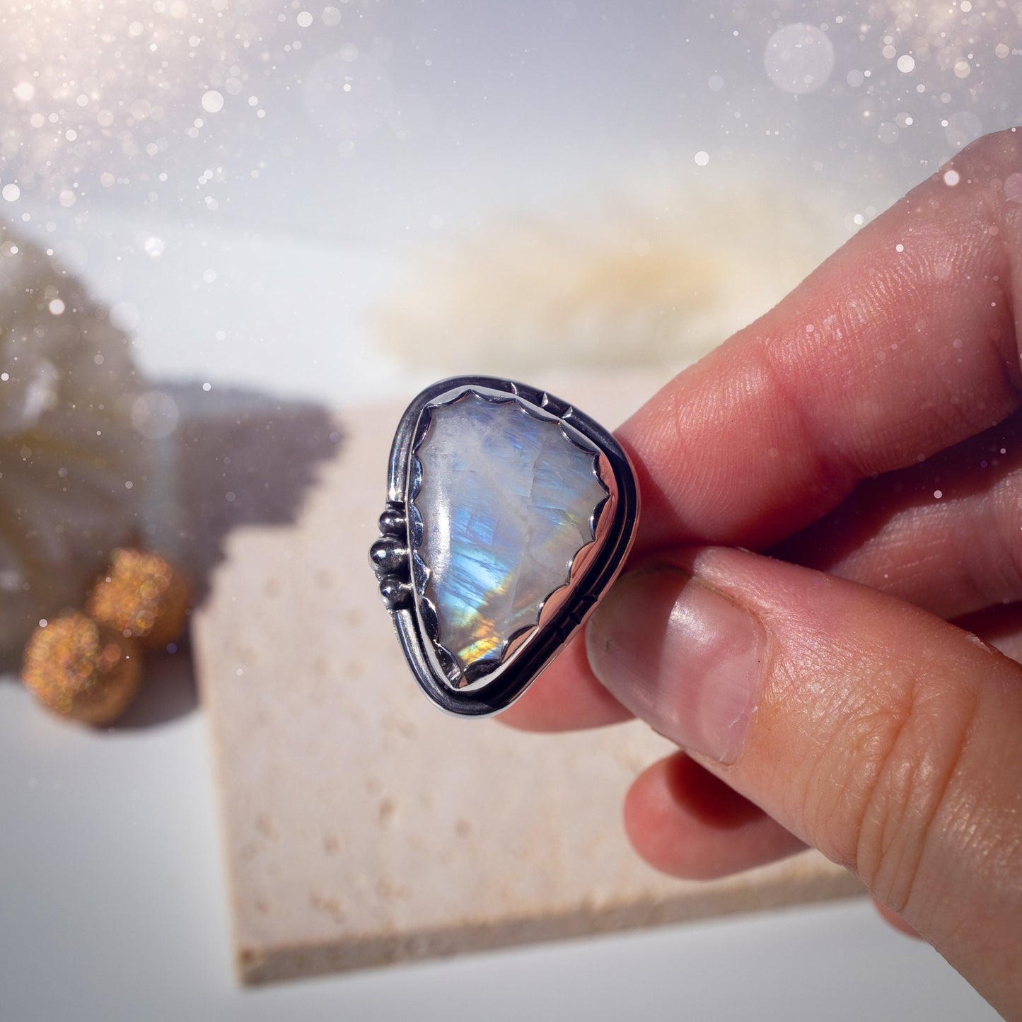 Beautiful Rainbow Moonstone ring set in fine and sterling silver. Featuring a scallop bezel, stars on the ring shank and silver accents. Size P