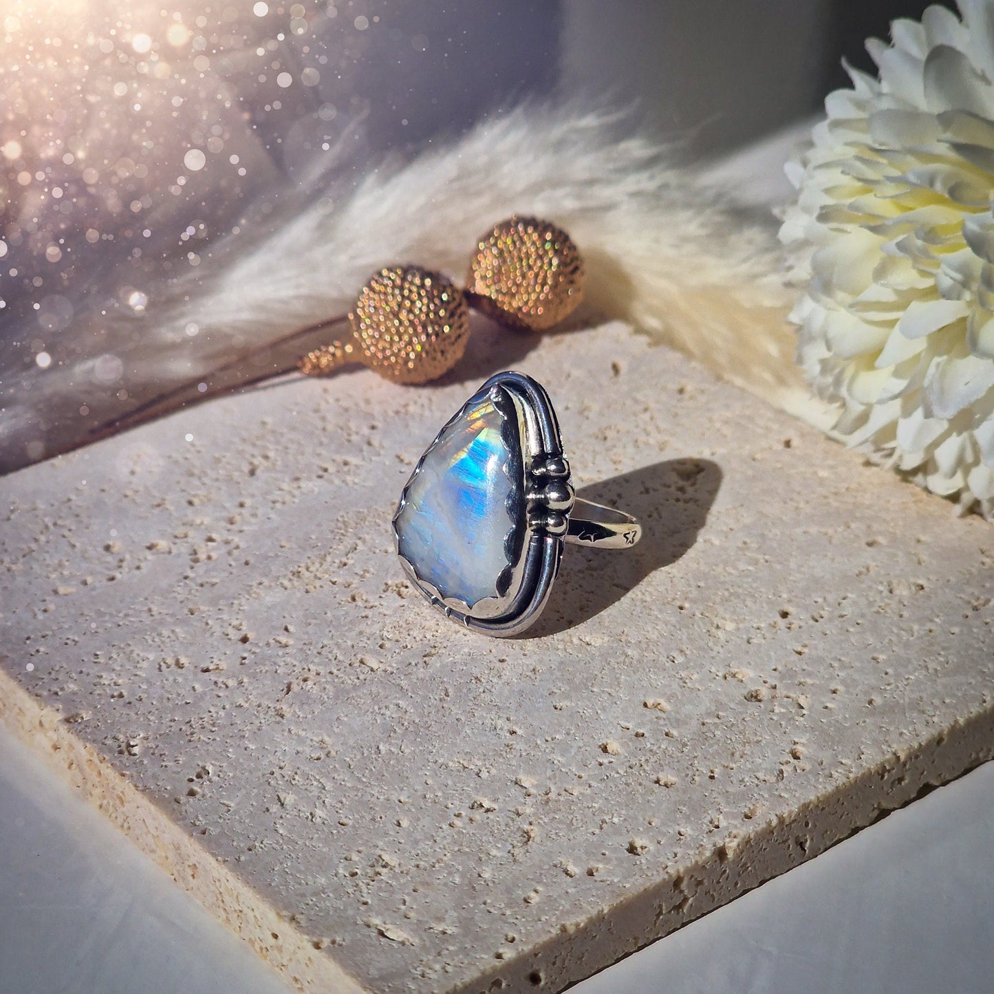 Beautiful Rainbow Moonstone ring set in fine and sterling silver. Featuring a scallop bezel, stars on the ring shank and silver accents. Size P