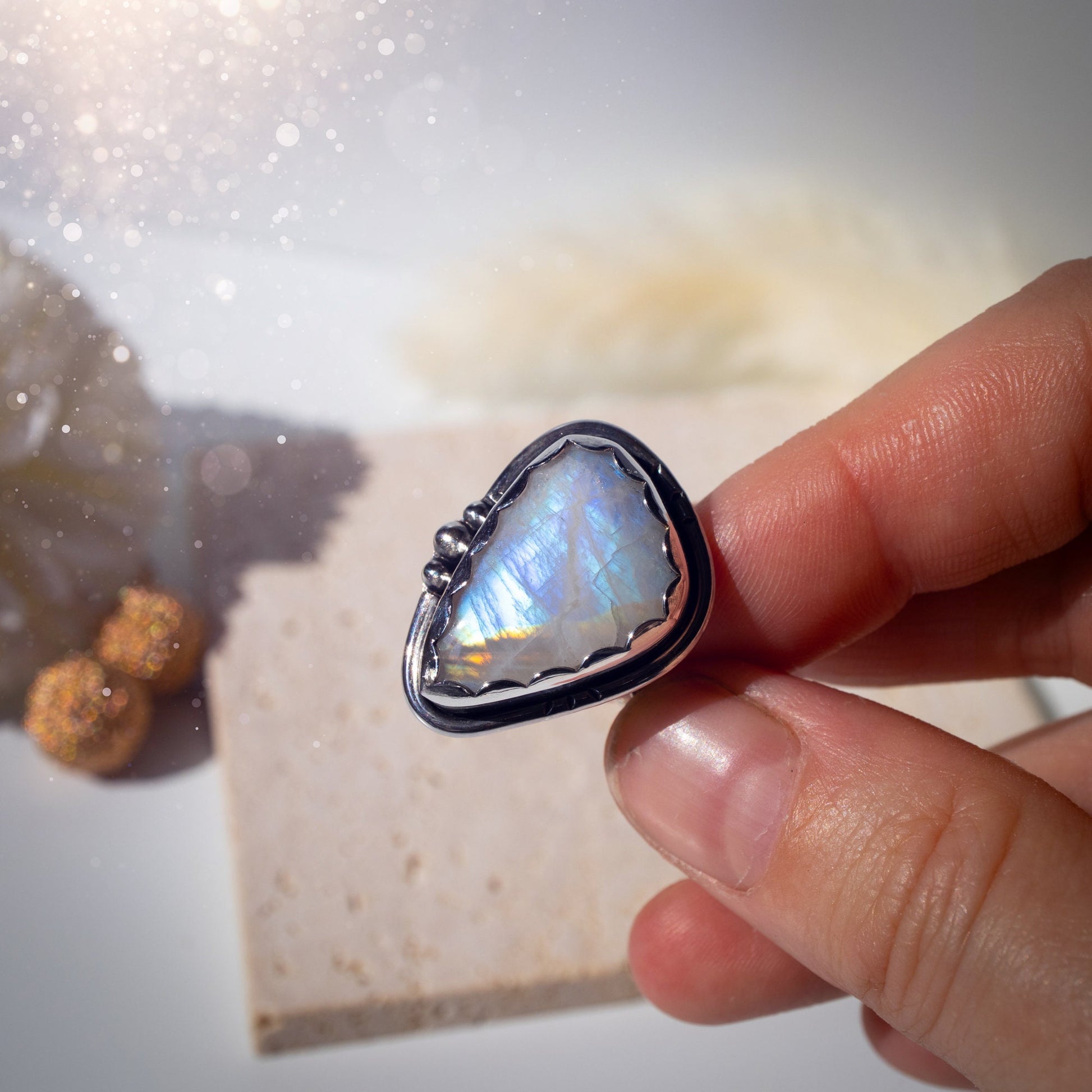 Beautiful Rainbow Moonstone ring set in fine and sterling silver. Featuring a scallop bezel, stars on the ring shank and silver accents. Size P