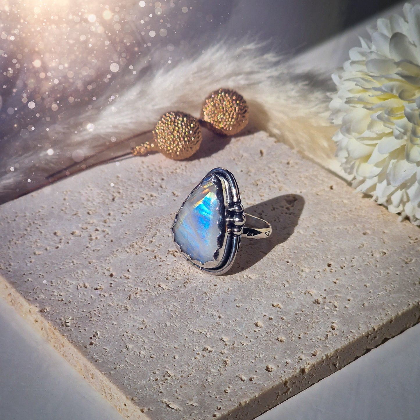 Beautiful Rainbow Moonstone ring set in fine and sterling silver. Featuring a scallop bezel, stars on the ring shank and silver accents. Size P