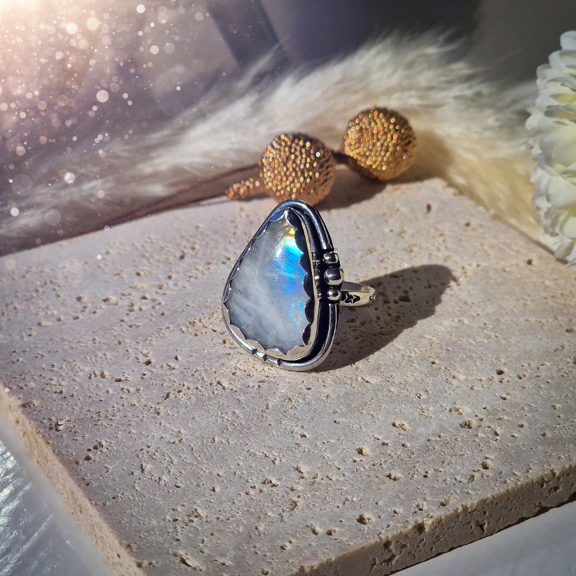 Beautiful Rainbow Moonstone ring set in fine and sterling silver. Featuring a scallop bezel, stars on the ring shank and silver accents. Size P